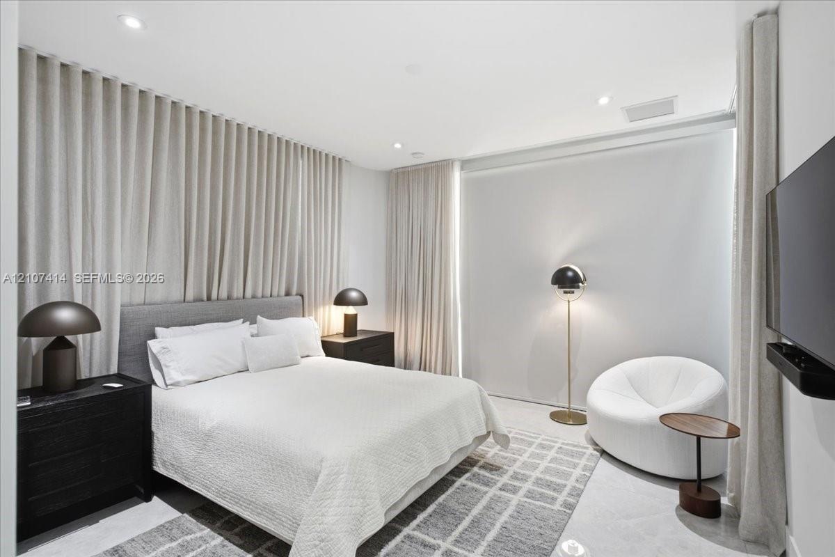 Wall-to-wall floor-to-ceiling drapery, recessed ceiling lighting, and smooth surface flooring