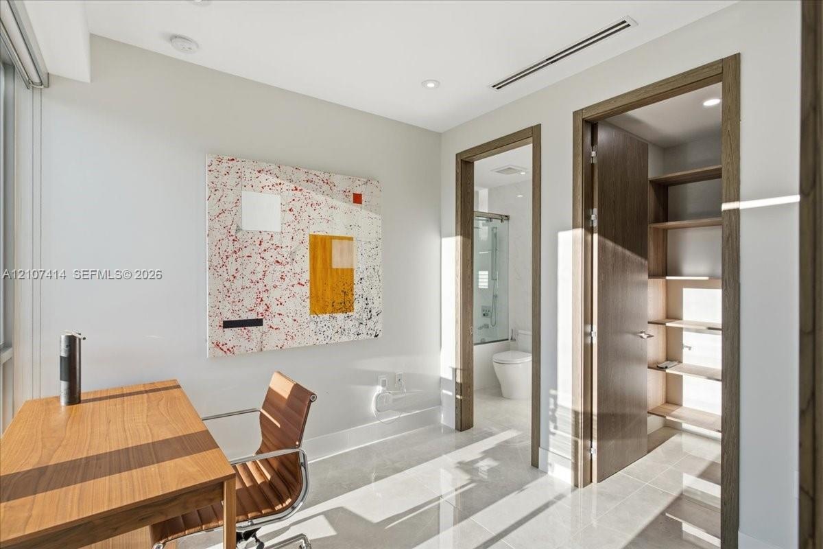 Polished stone flooring, recessed lighting, neutral wall finishes, custom walk-in closet shelving, and integrated climate control ductwork