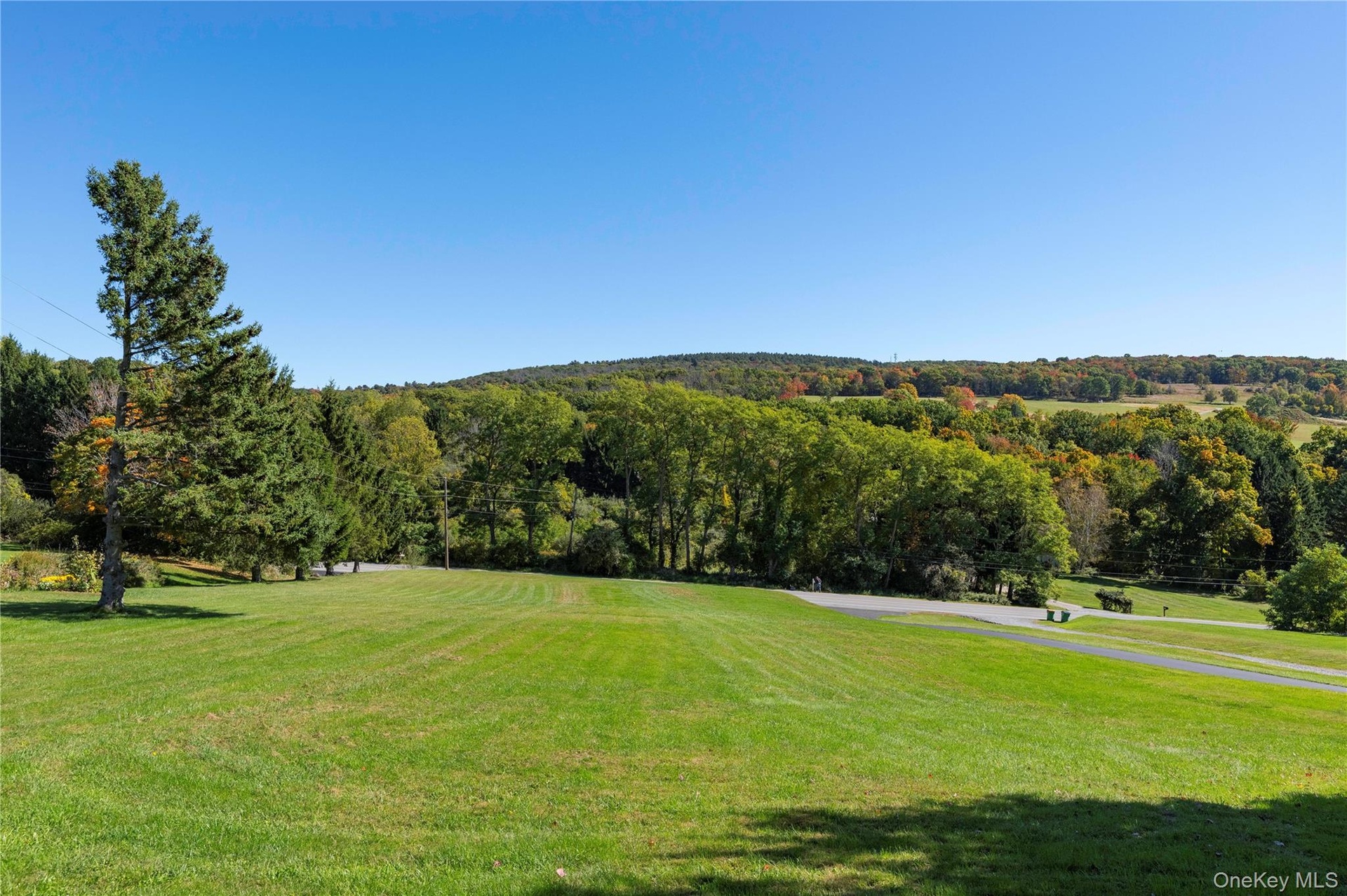 Expansive front yard with views of fields across the street