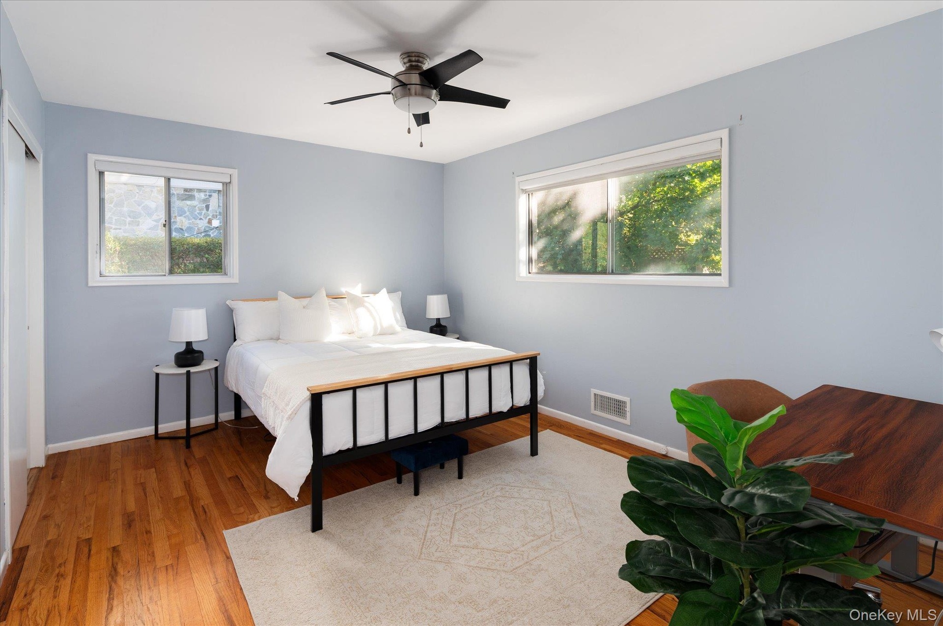 Tranquil primary bedroom faces back of house.