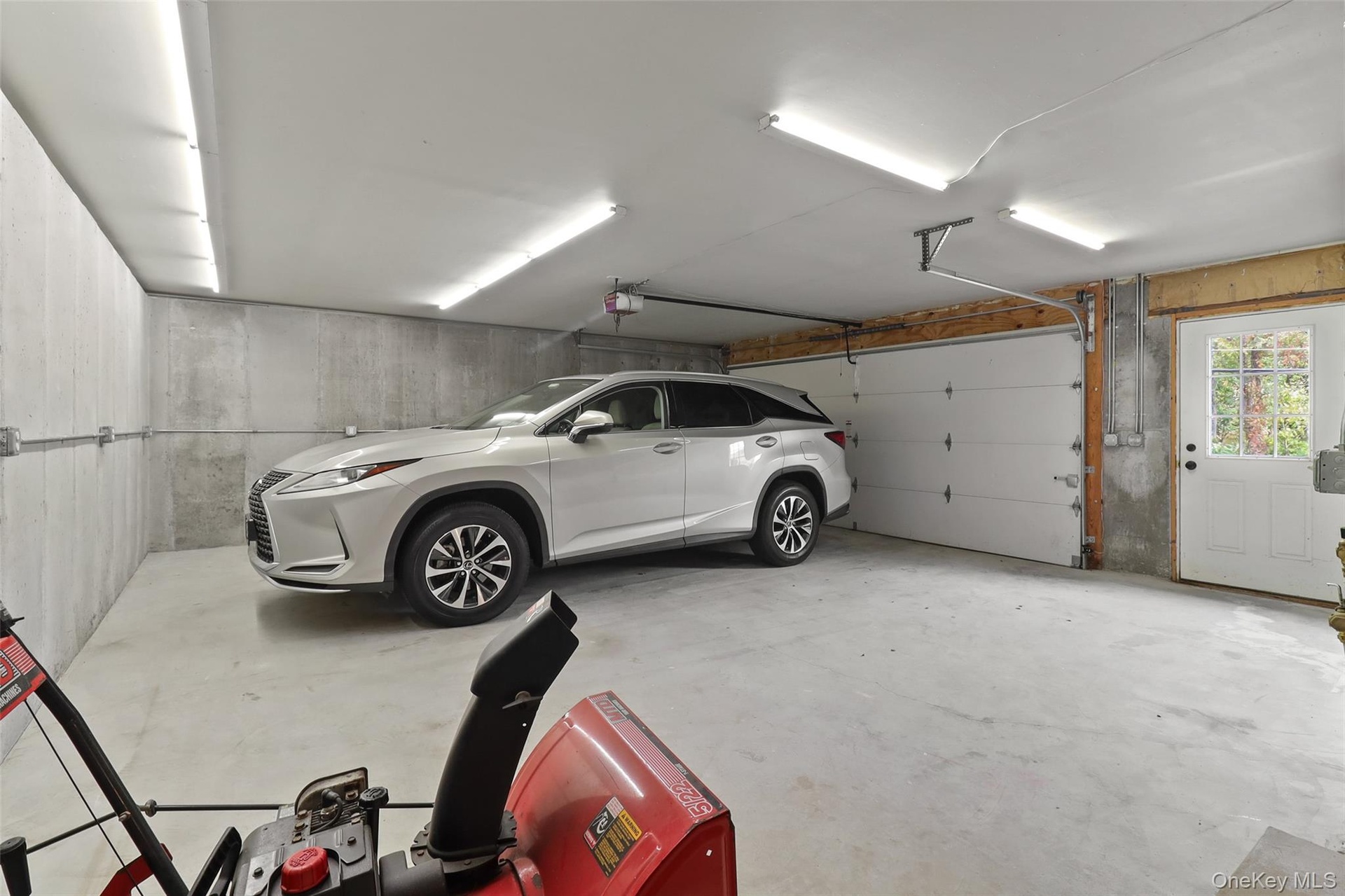 This well-lit, poured concrete two car garage with no pillars was added to the house in 2000.