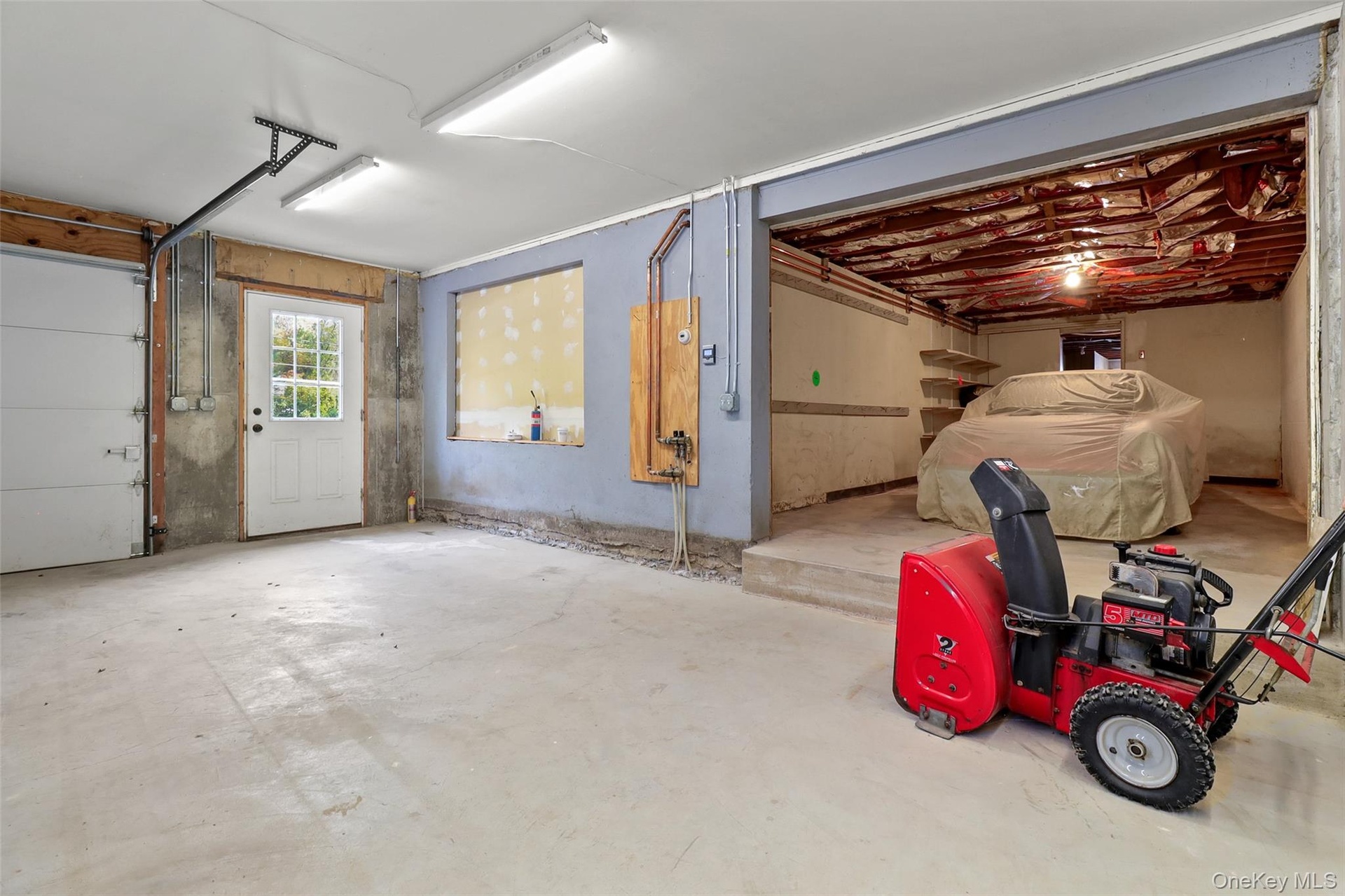 This two-car garage has a pre-existing 3rd car bay