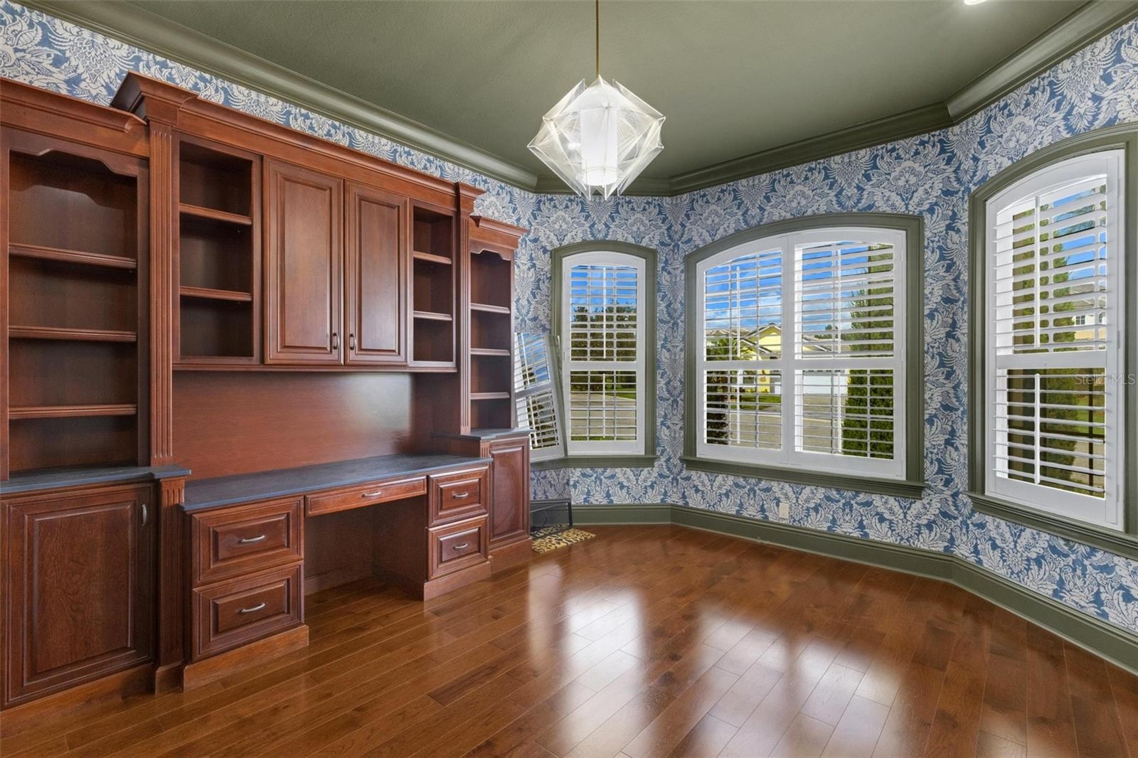 But there is still space for a desk, worktable, and a full wall of windows overlooking the front of the property.