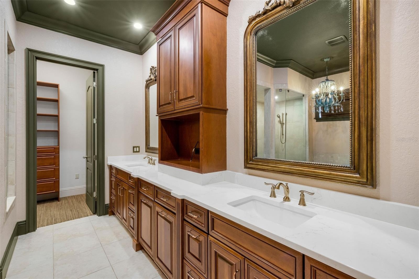 The ensuite bathroom features a long-split vanity with central tower for added storage.