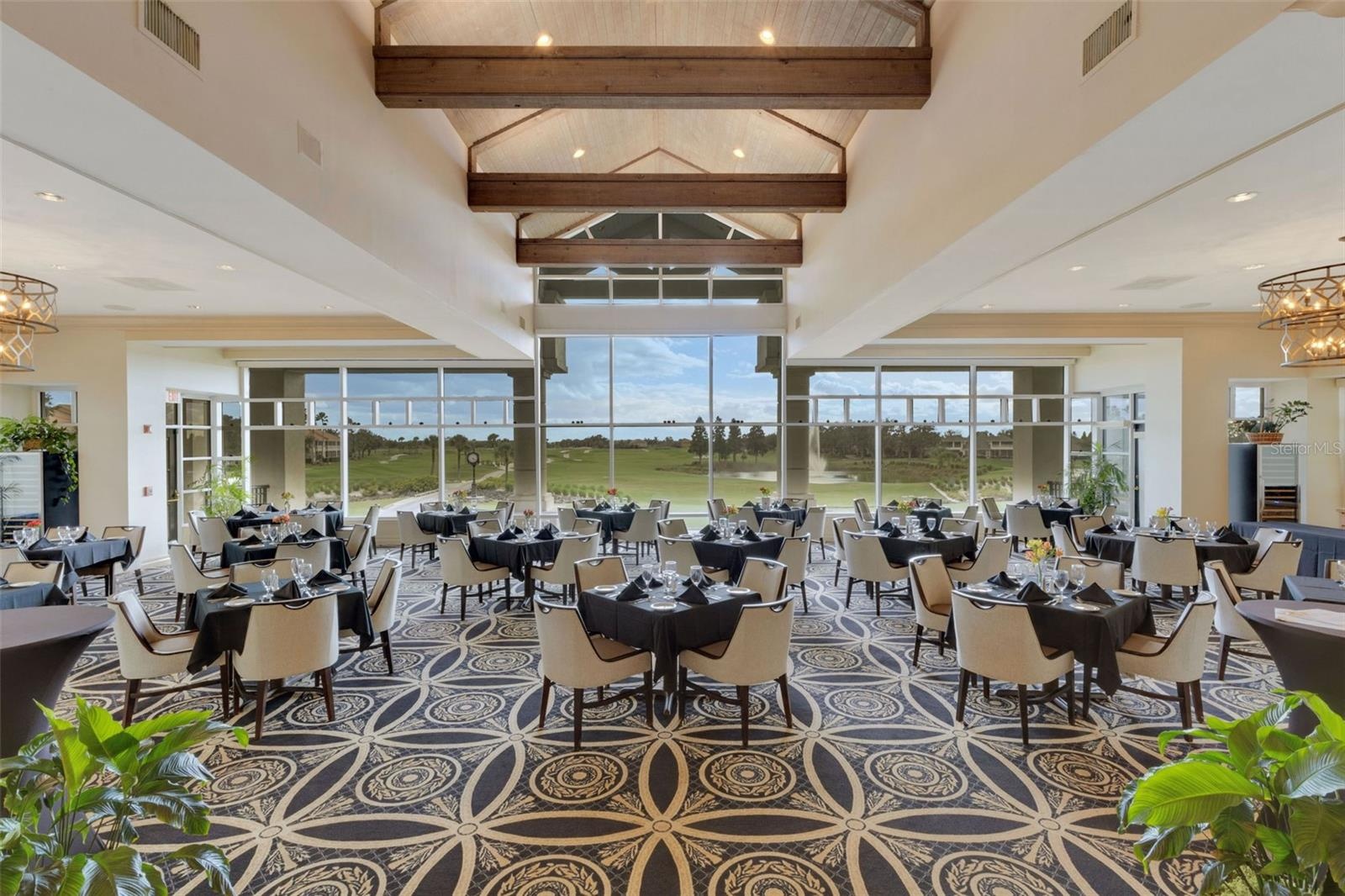 The elegant main dining room has stunning panoramic views of the golf course beyond.