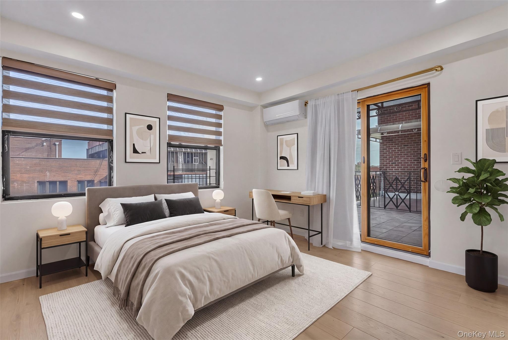 Wood-finish flooring, recessed lighting, dual-pane windows with integrated blinds, wall-mounted ductless climate control system, and a sliding glass d