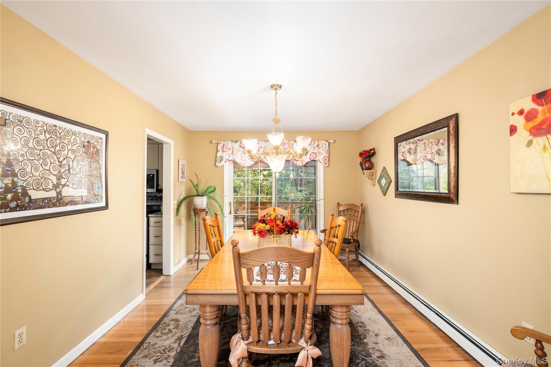 Dining area featuring wood flooring,  and wide archway to living room