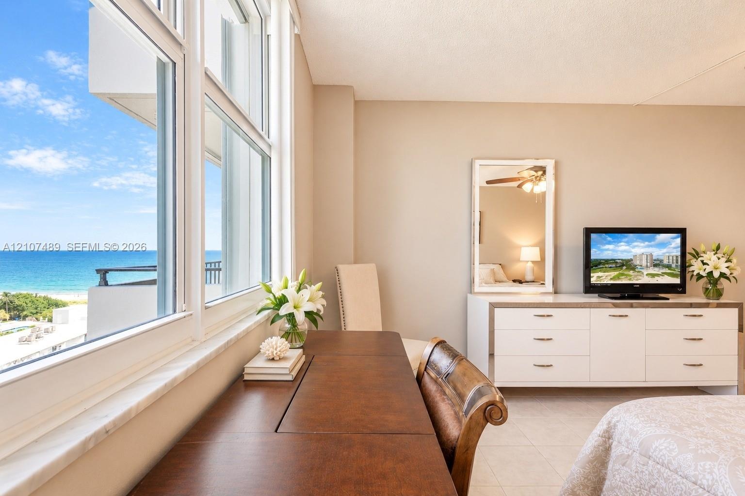 Large multi-pane window featuring a stone sill and expansive ocean and coastal scenery