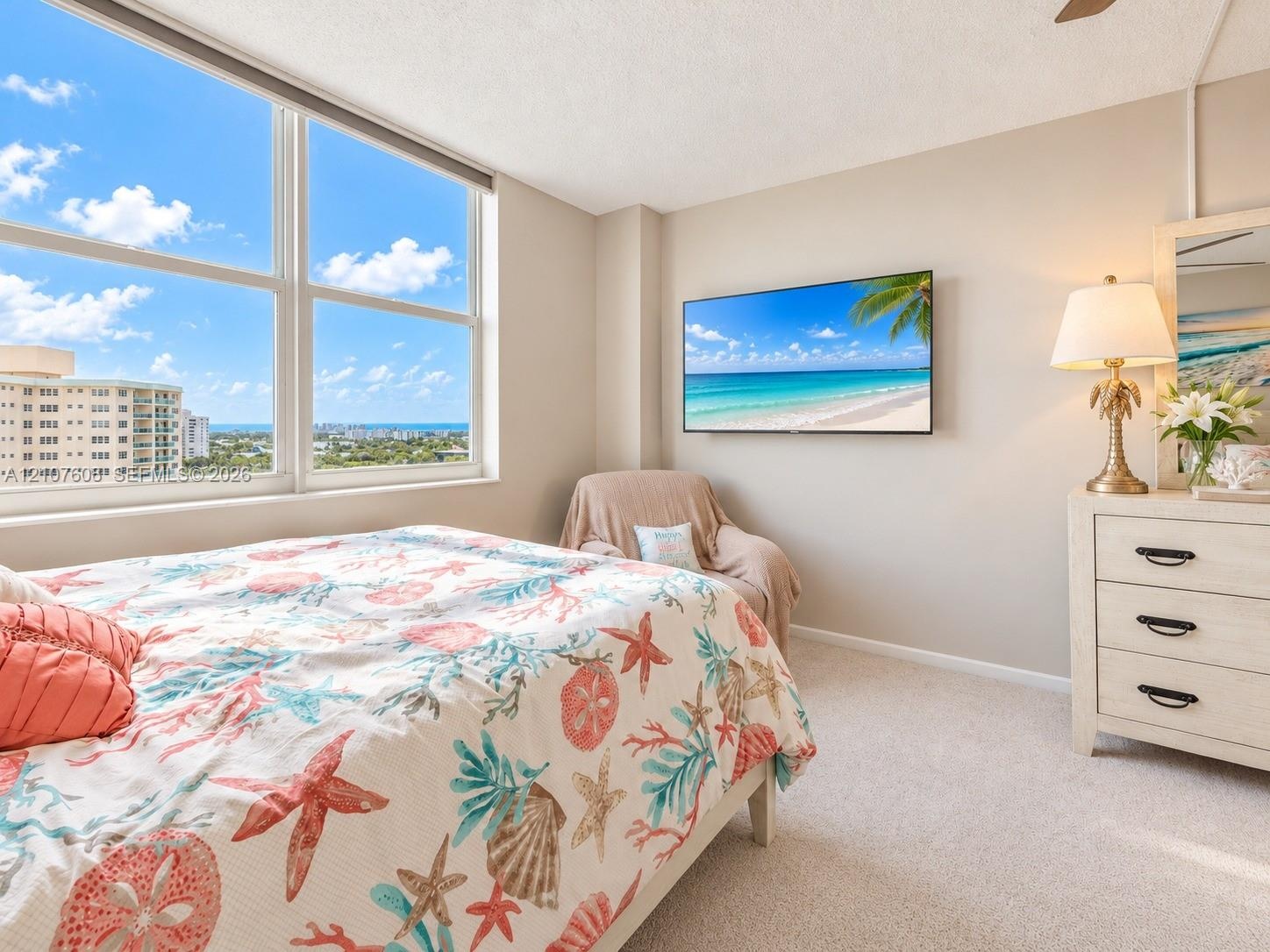 Large-format windows featuring expansive exterior scenery, neutral wall tones, and wall-to-wall carpeting