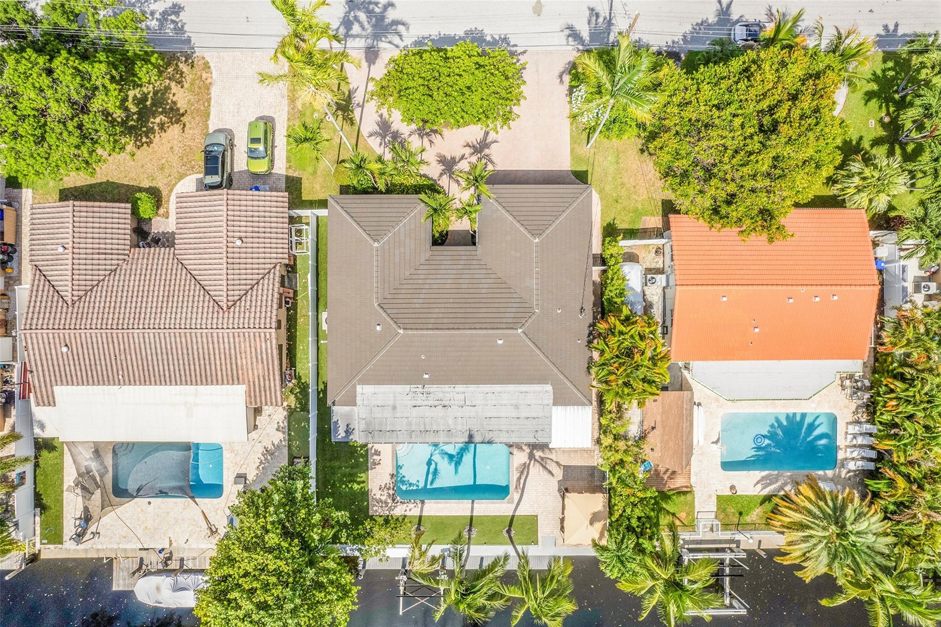Property featuring a tiled roof, private swimming pool, and mature landscaping