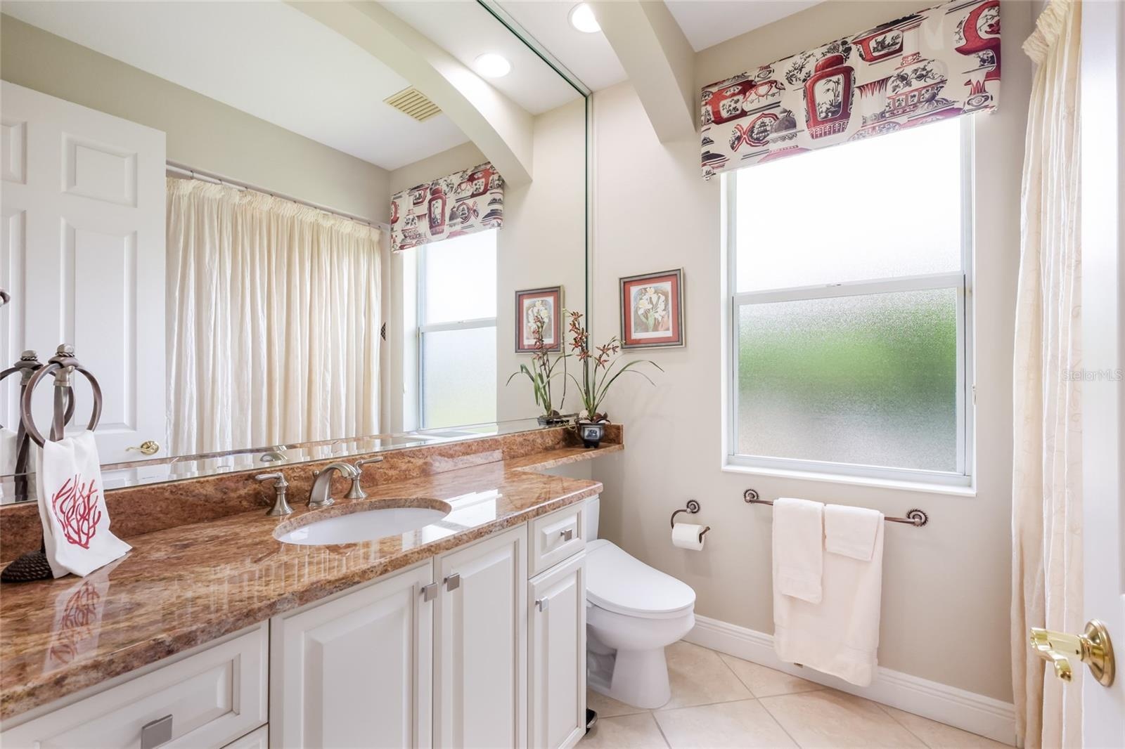 Guest bath between bedroom 3 and 4 also serves as pool bath