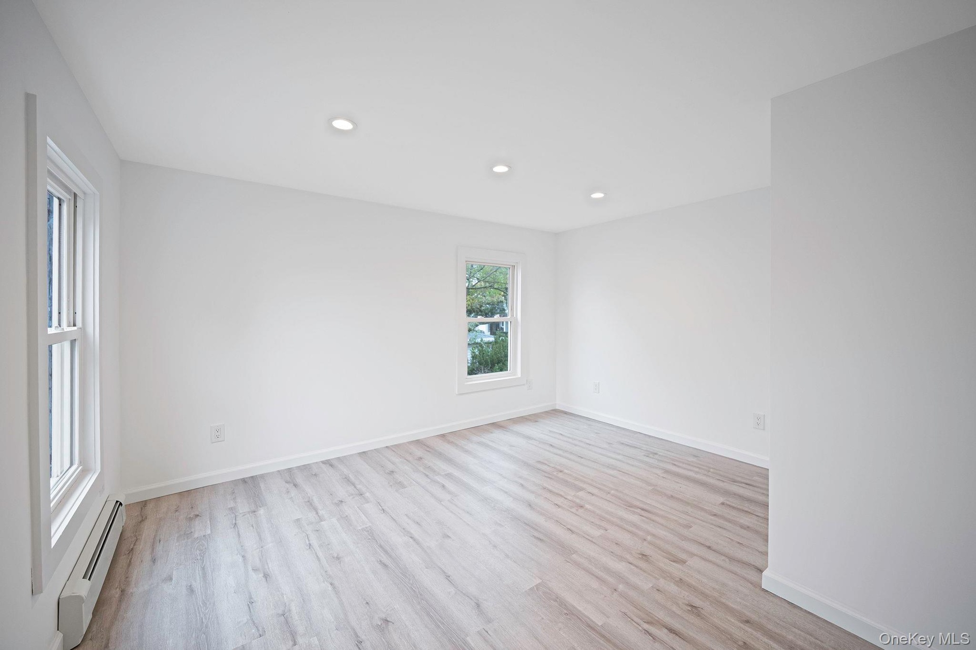 Bright interior space featuring vinyl wood-finish flooring, recessed lighting, and double-pane windows