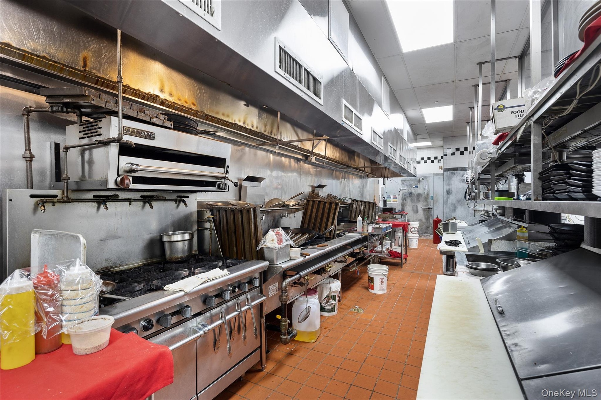 Kitchen featuring high end stainless steel range oven and a paneled ceiling
