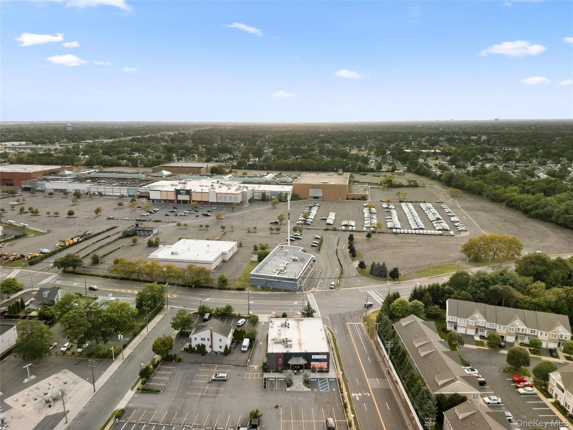 Aerial overview of property's location featuring a tree filled landscape