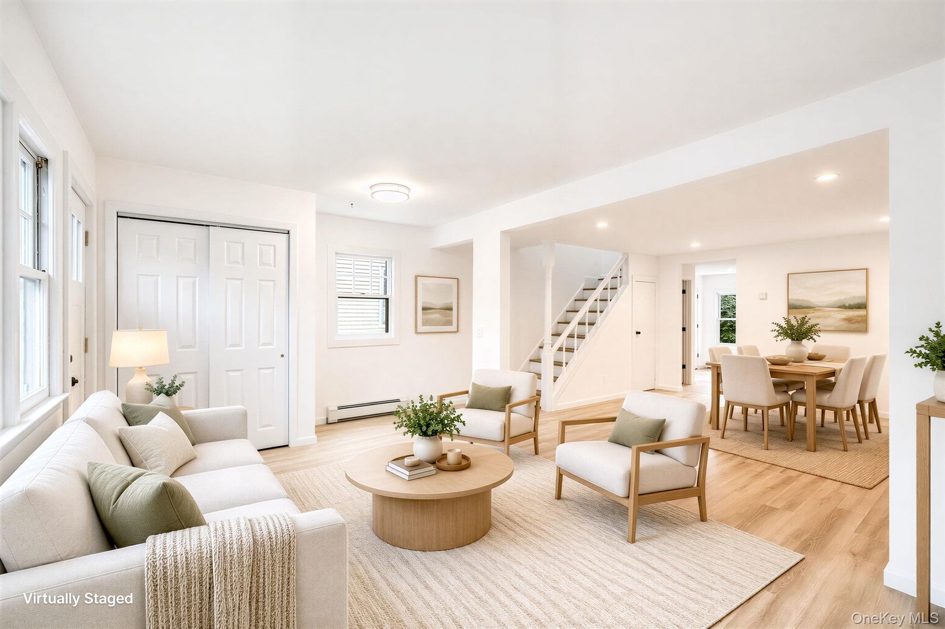 Open-concept interior featuring wood-finish flooring, recessed lighting, double-panel sliding closet doors, and a staircase with white balusters *virt