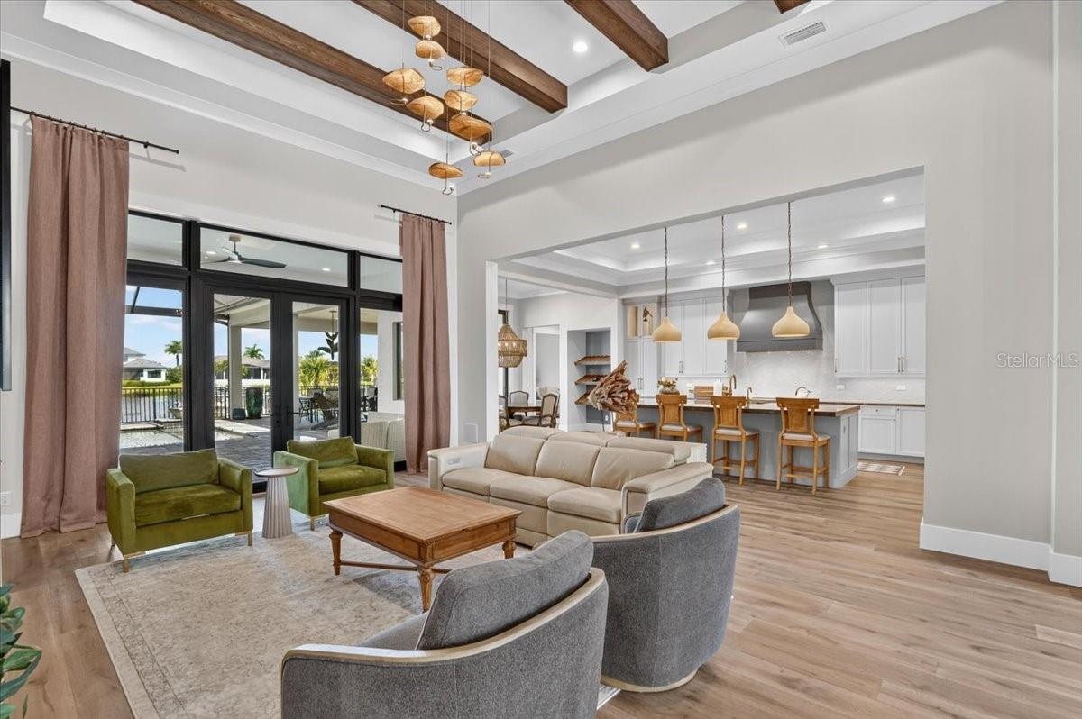 Wood Beams, Designer Lighting and Custom PGT French Doors