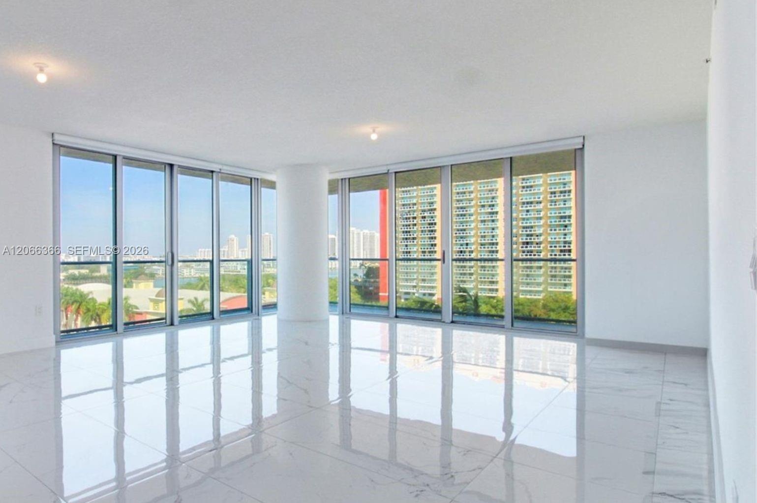 Floor-to-ceiling windows, polished stone-finish flooring, structural column, and recessed ceiling lighting