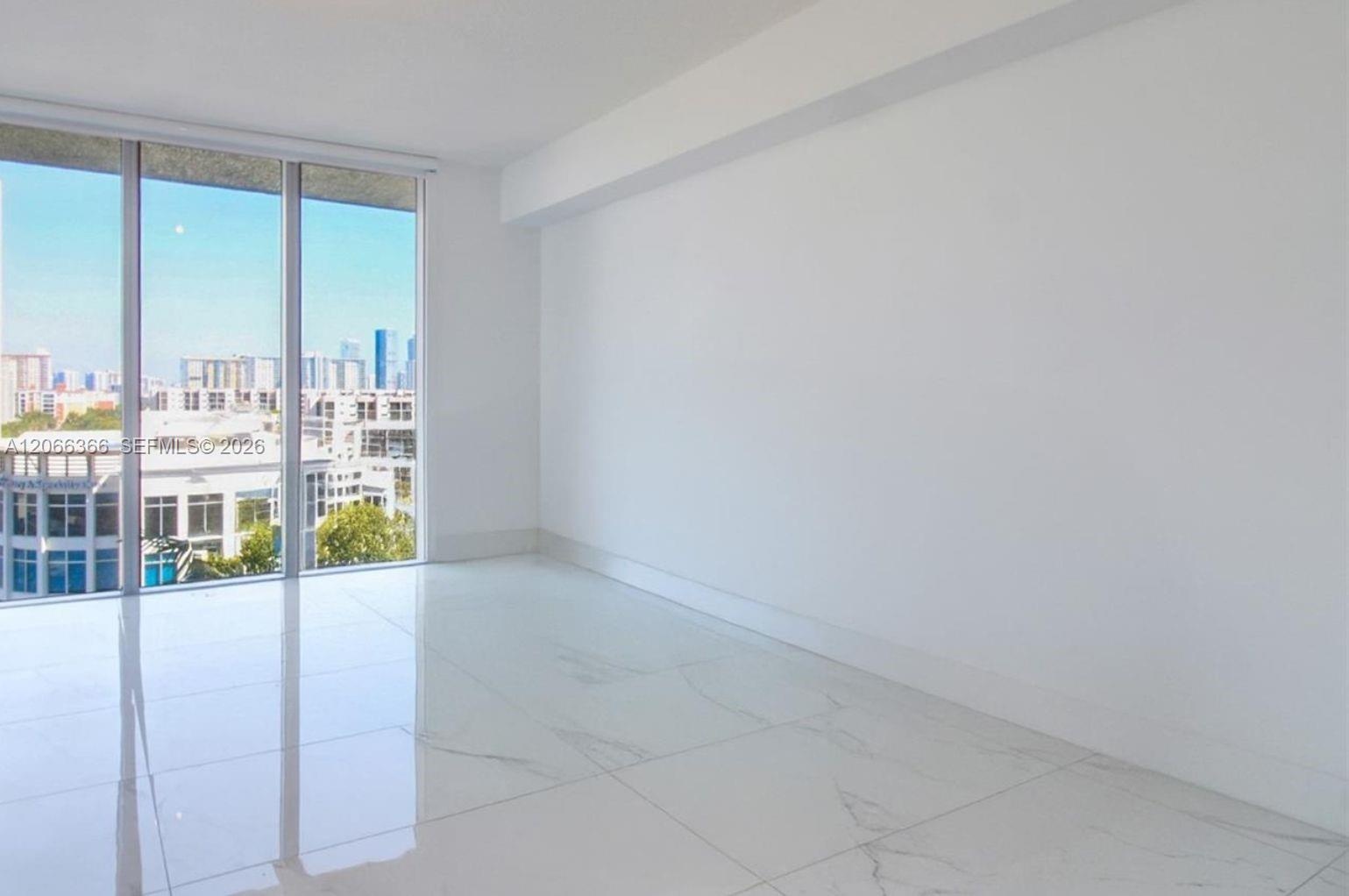 Floor-to-ceiling windows, large-format polished tile flooring, and urban skyline backdrop
