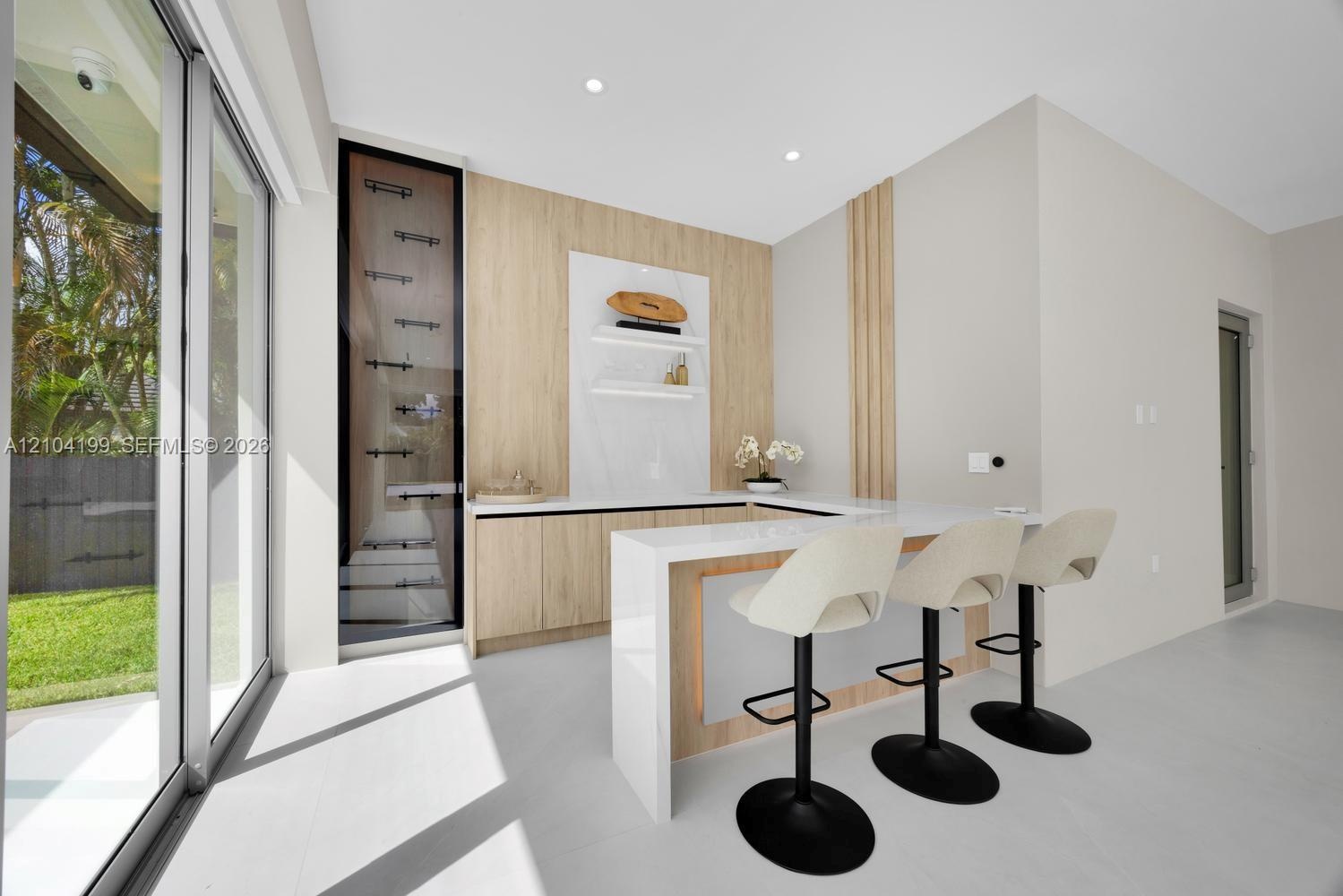 Built-in bar featuring wood-finish cabinetry, stone-surface countertops, integrated shelving, and vertical wood paneling, complemented by floor-to-cei