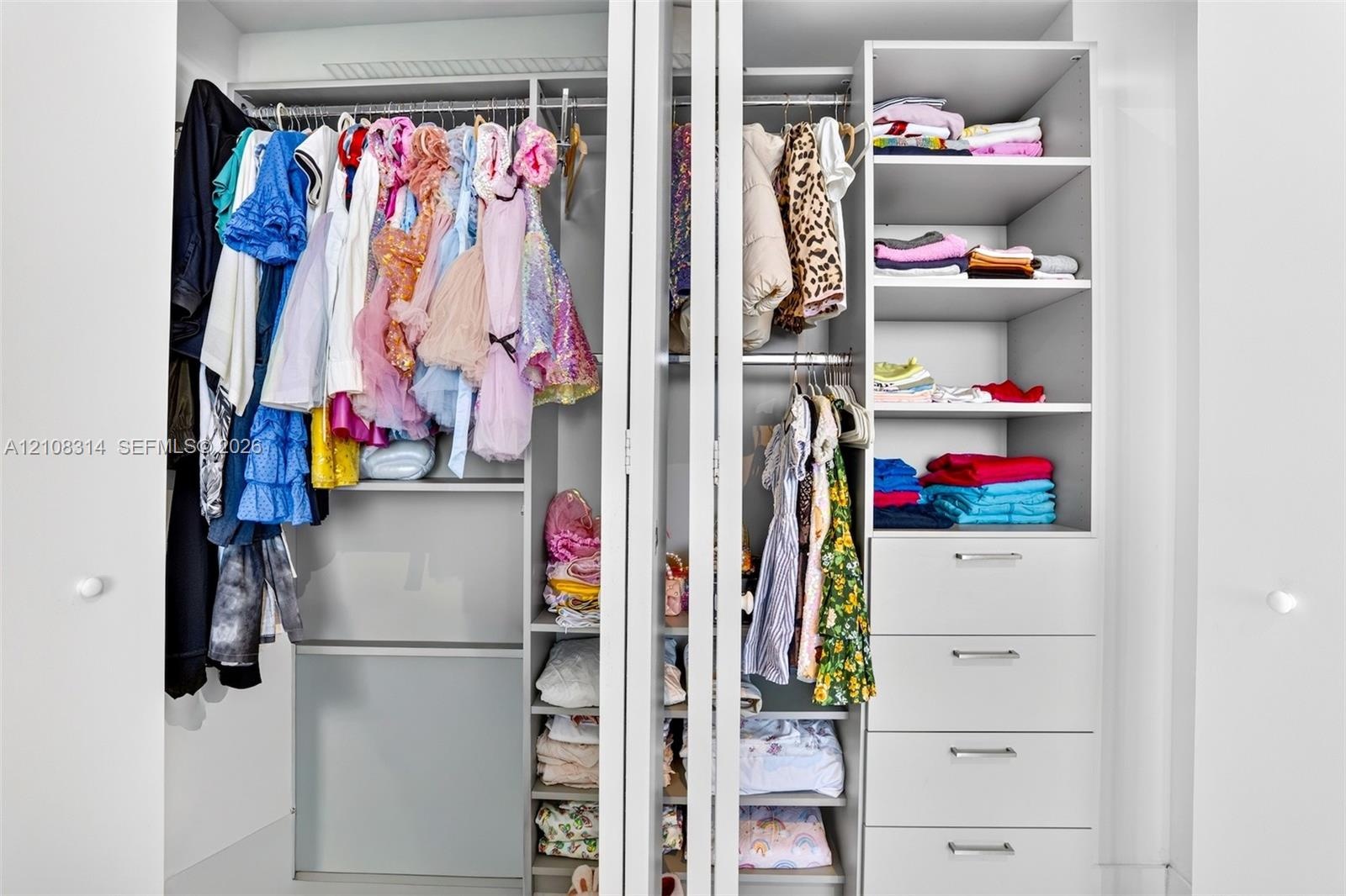 Built-in closet system featuring dual hanging rods, four integrated storage drawers, and multiple open-concept shelving units with a matte white finis