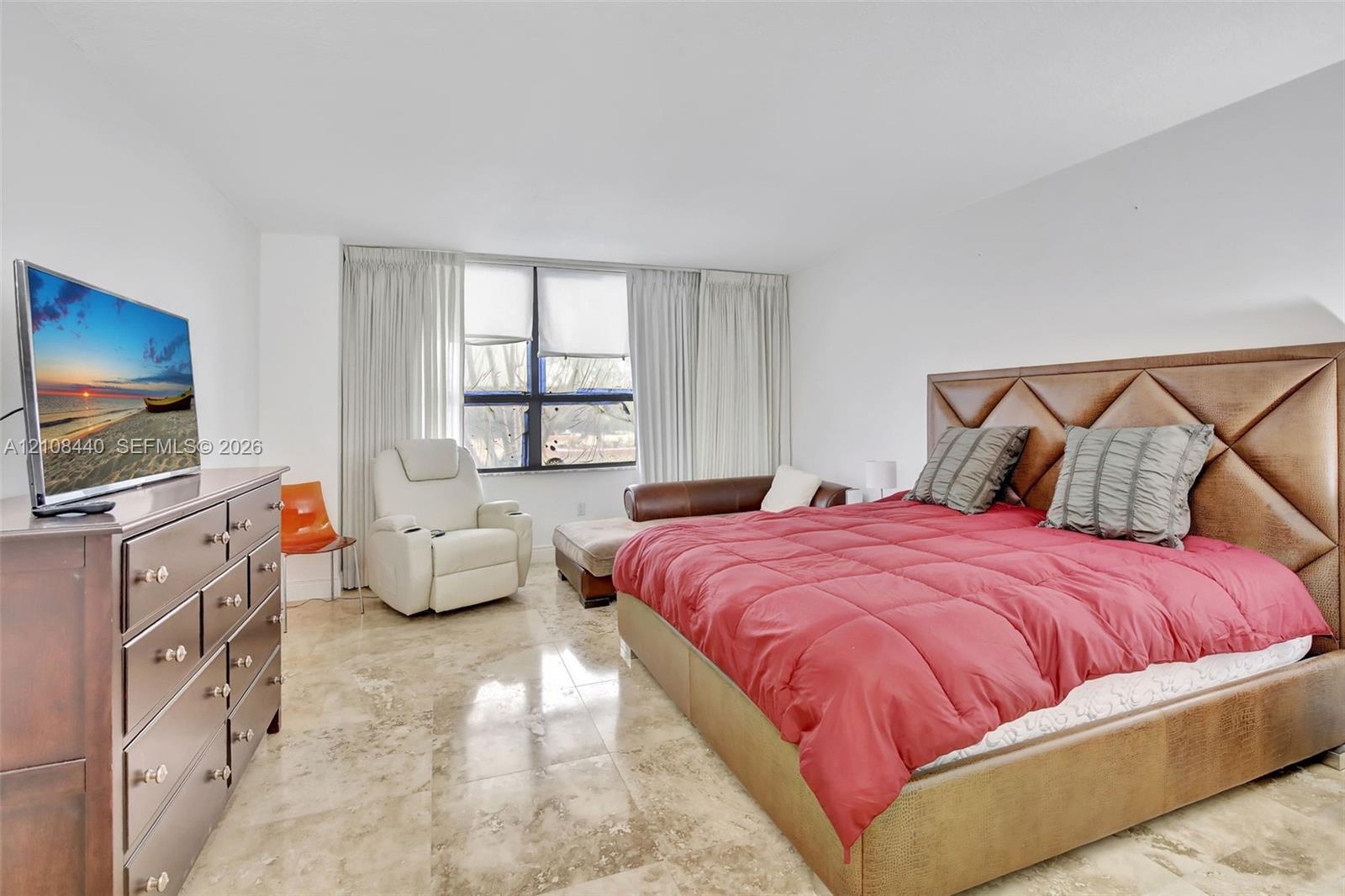 Polished stone flooring, floor-to-ceiling windows, and recessed lighting