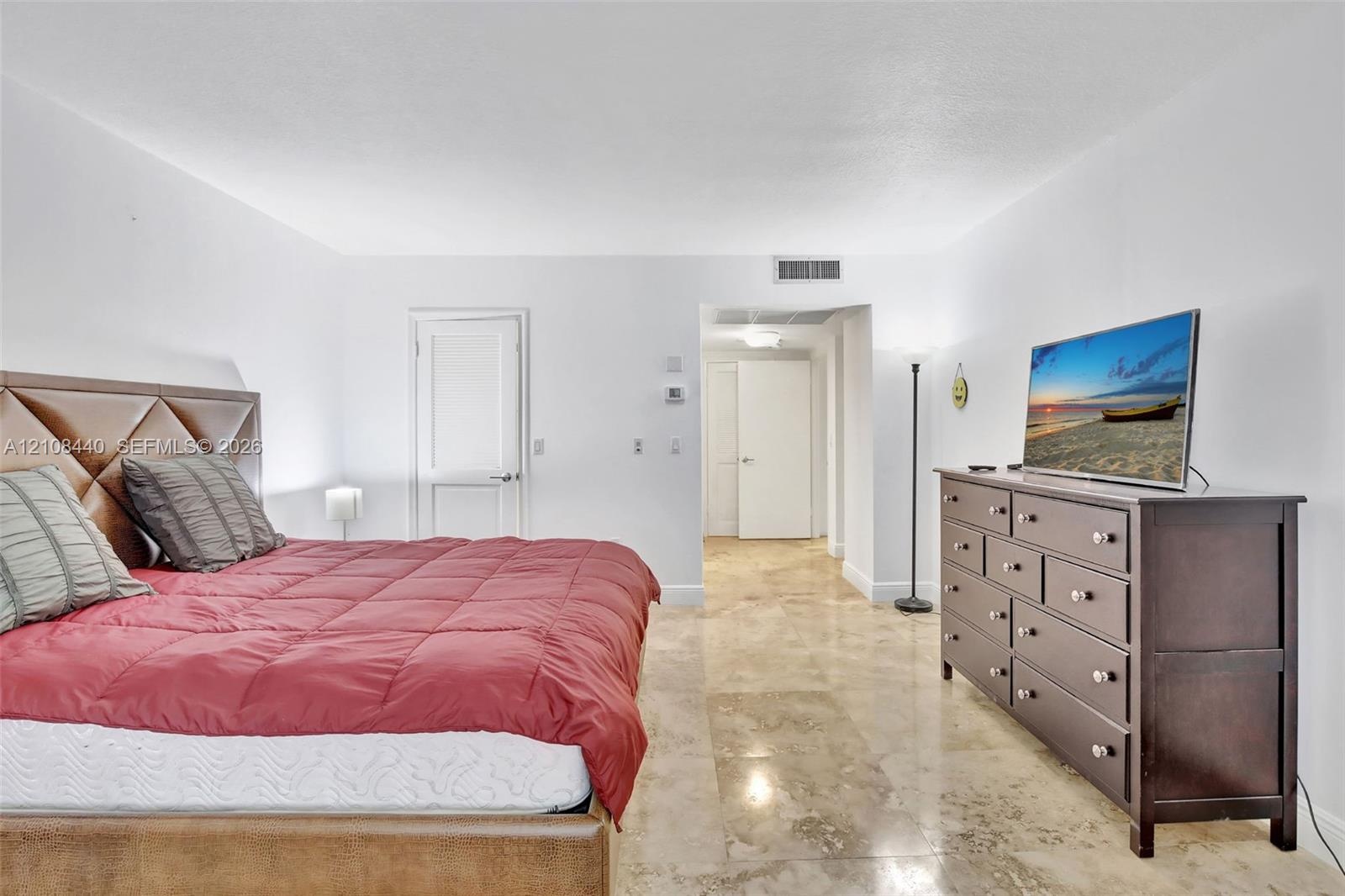 Polished stone flooring throughout and multi-panel interior doors