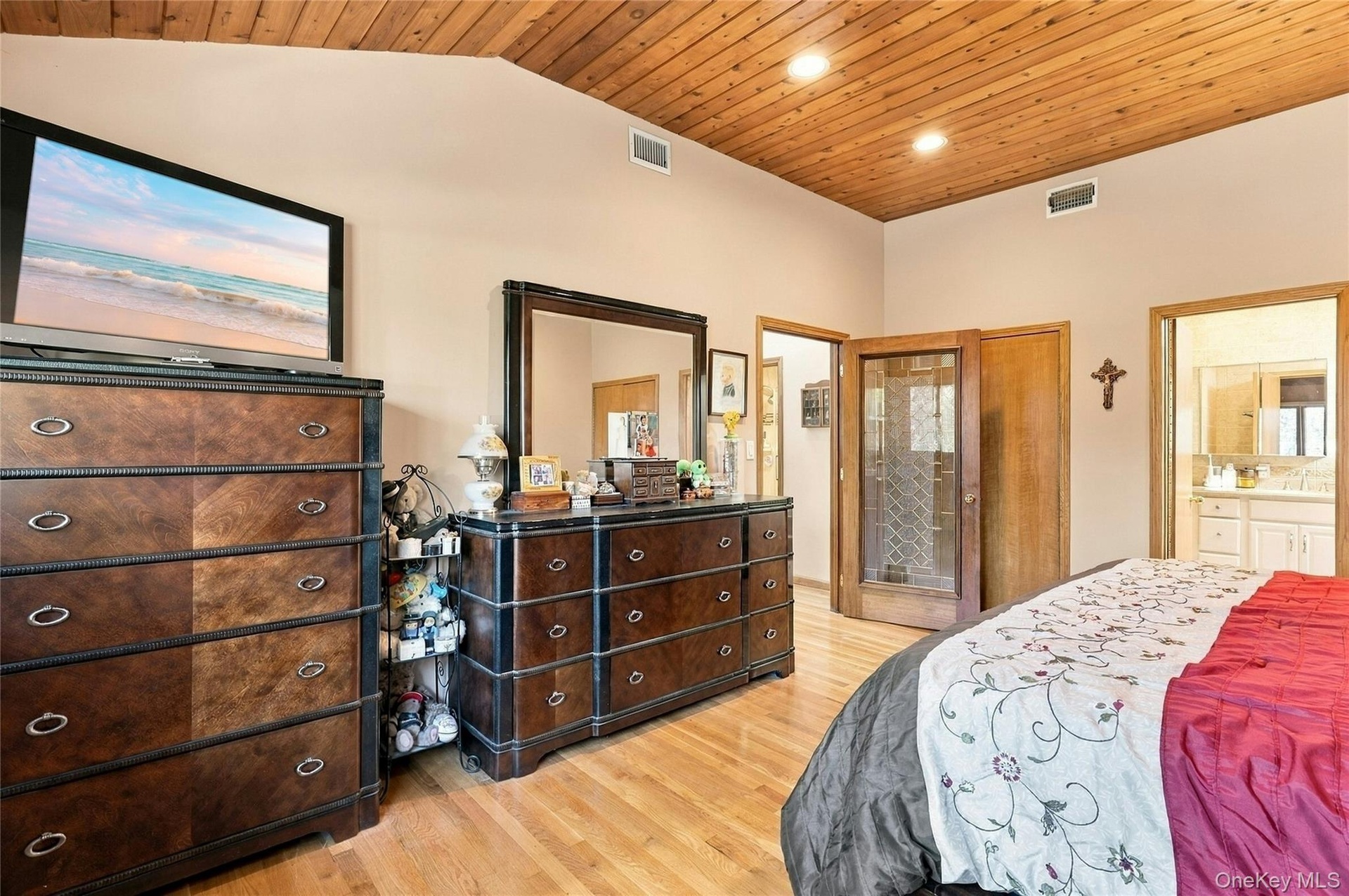 Vaulted ceiling with wood-plank paneling, recessed lighting, and wood-finish flooring