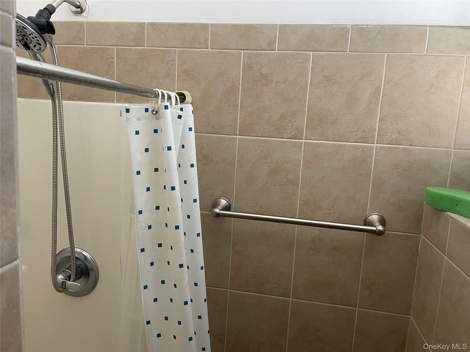 Bathroom featuring curtained shower