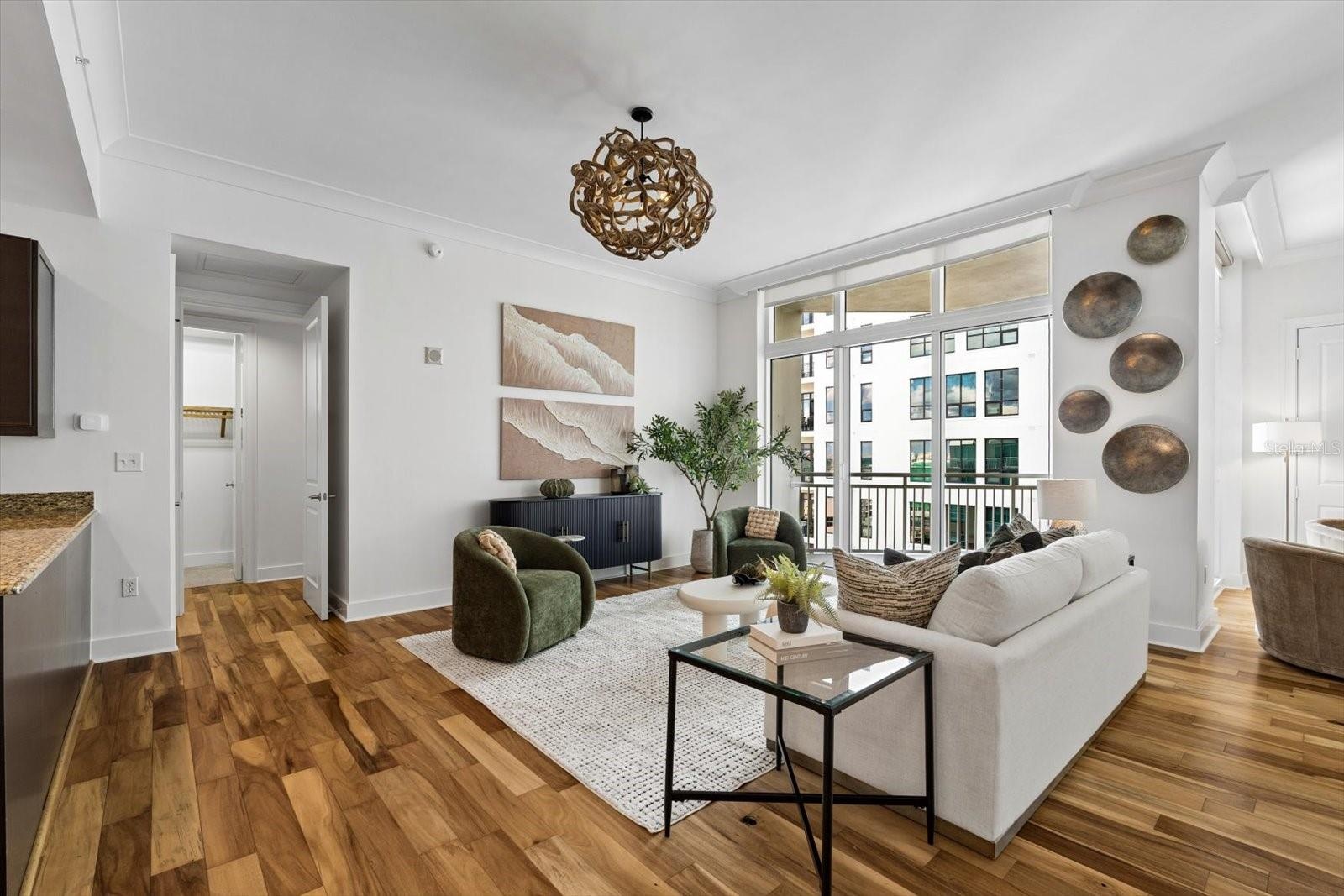Living room with tall sliders out to a covered balcony