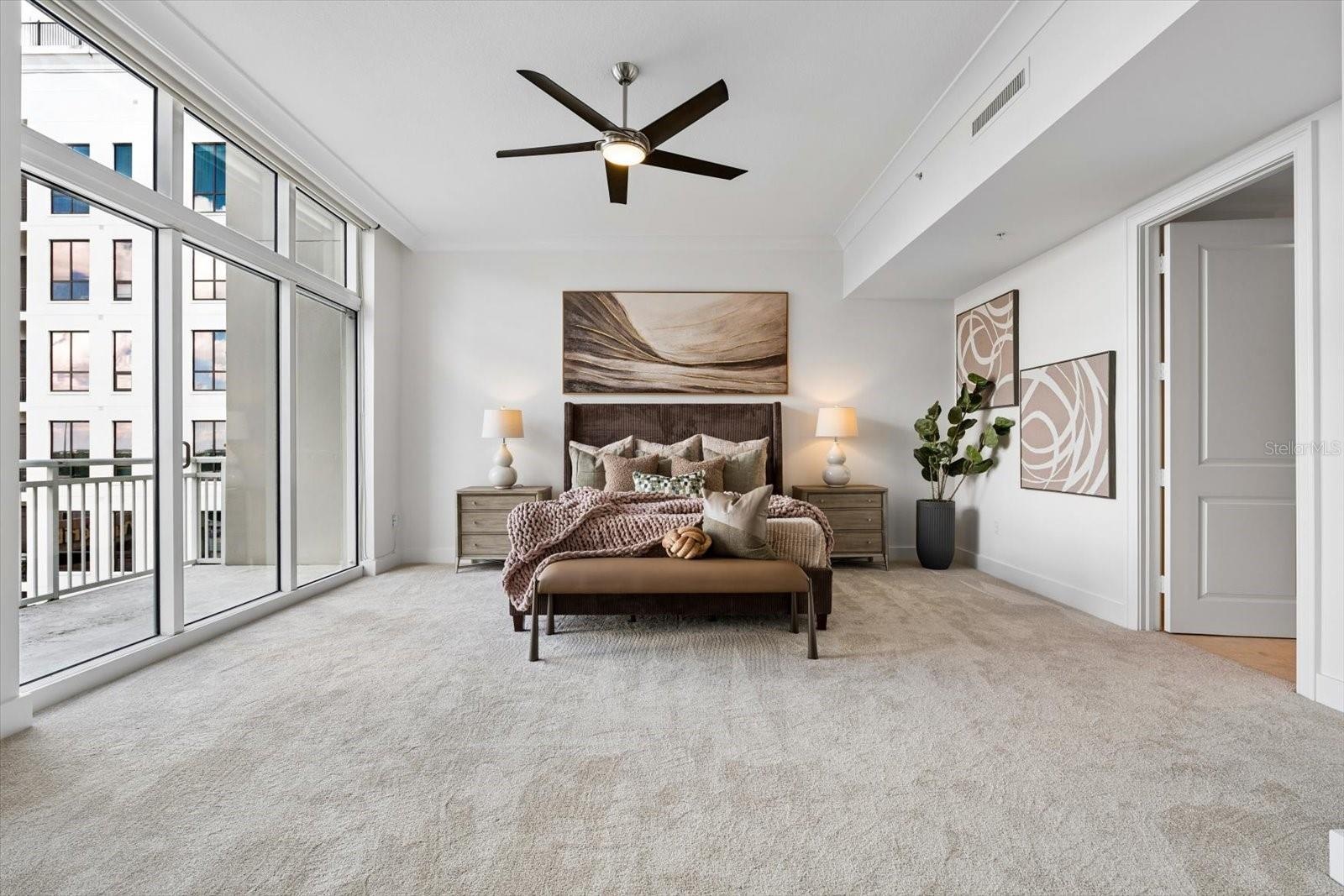 Oversized primary ensuite bedroom with private covered balcony