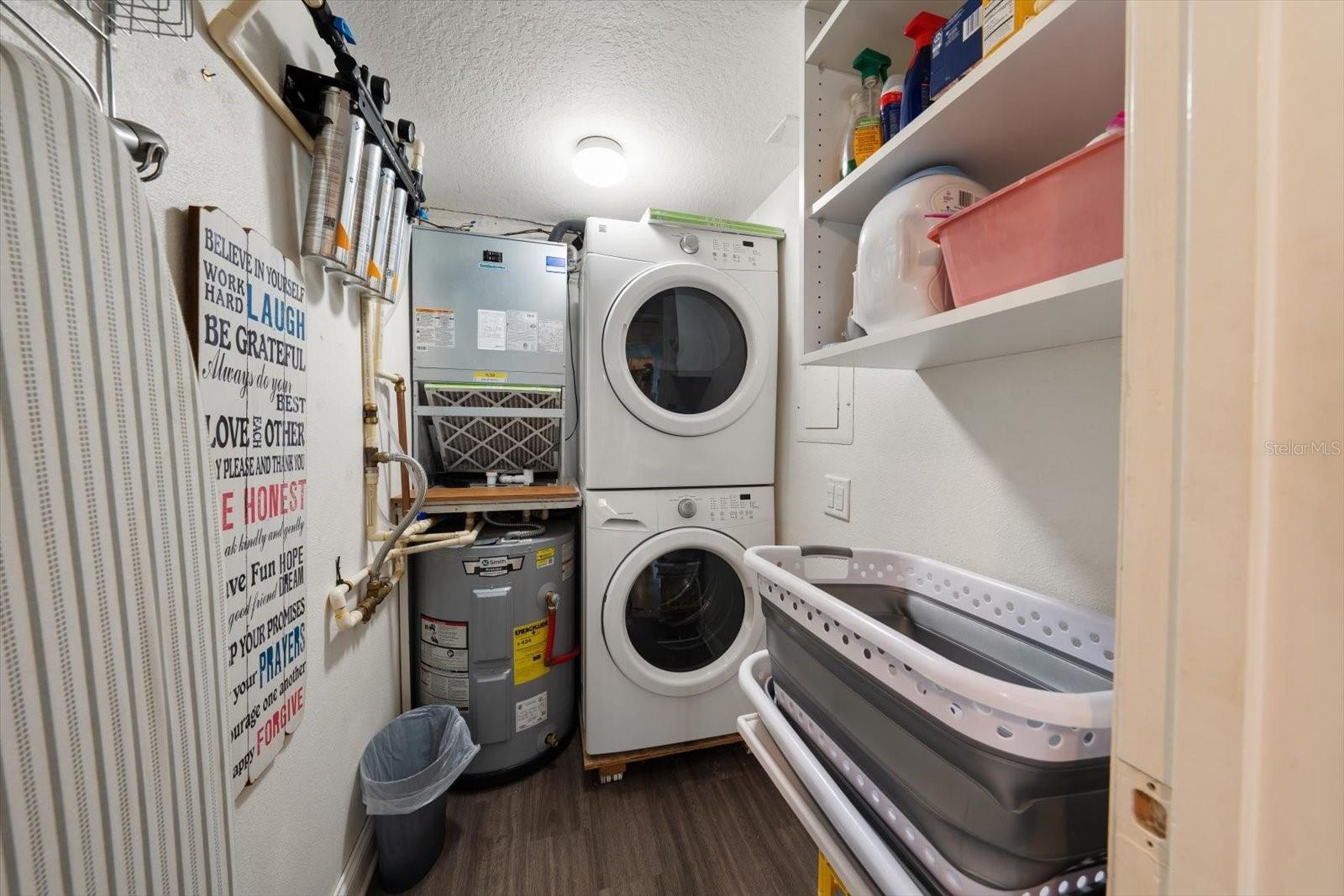 Inside laundry room with storage