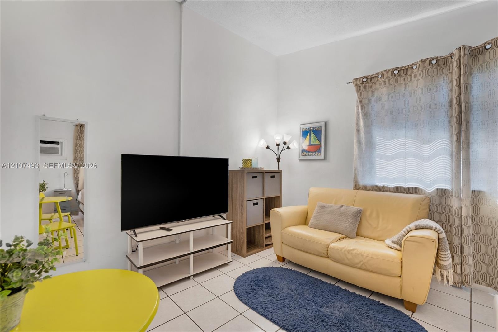 High ceilings with neutral wall finish and ceramic tile flooring