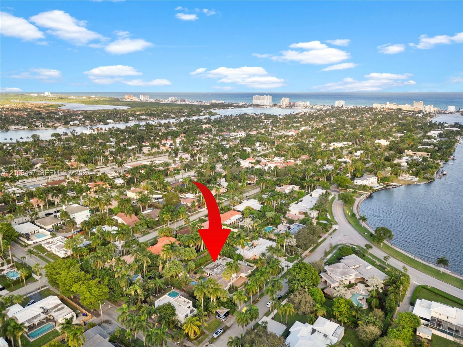 Aerial perspective featuring a residential lot situated within a coastal neighborhood, highlighted by proximity to regional waterways and established 