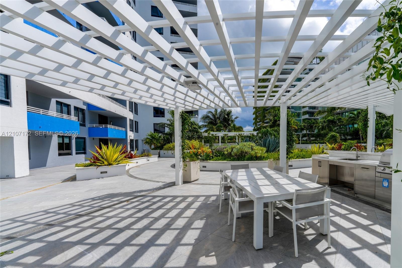 Expansive rooftop terrace featuring large-format tile flooring and a frameless glass perimeter railing
