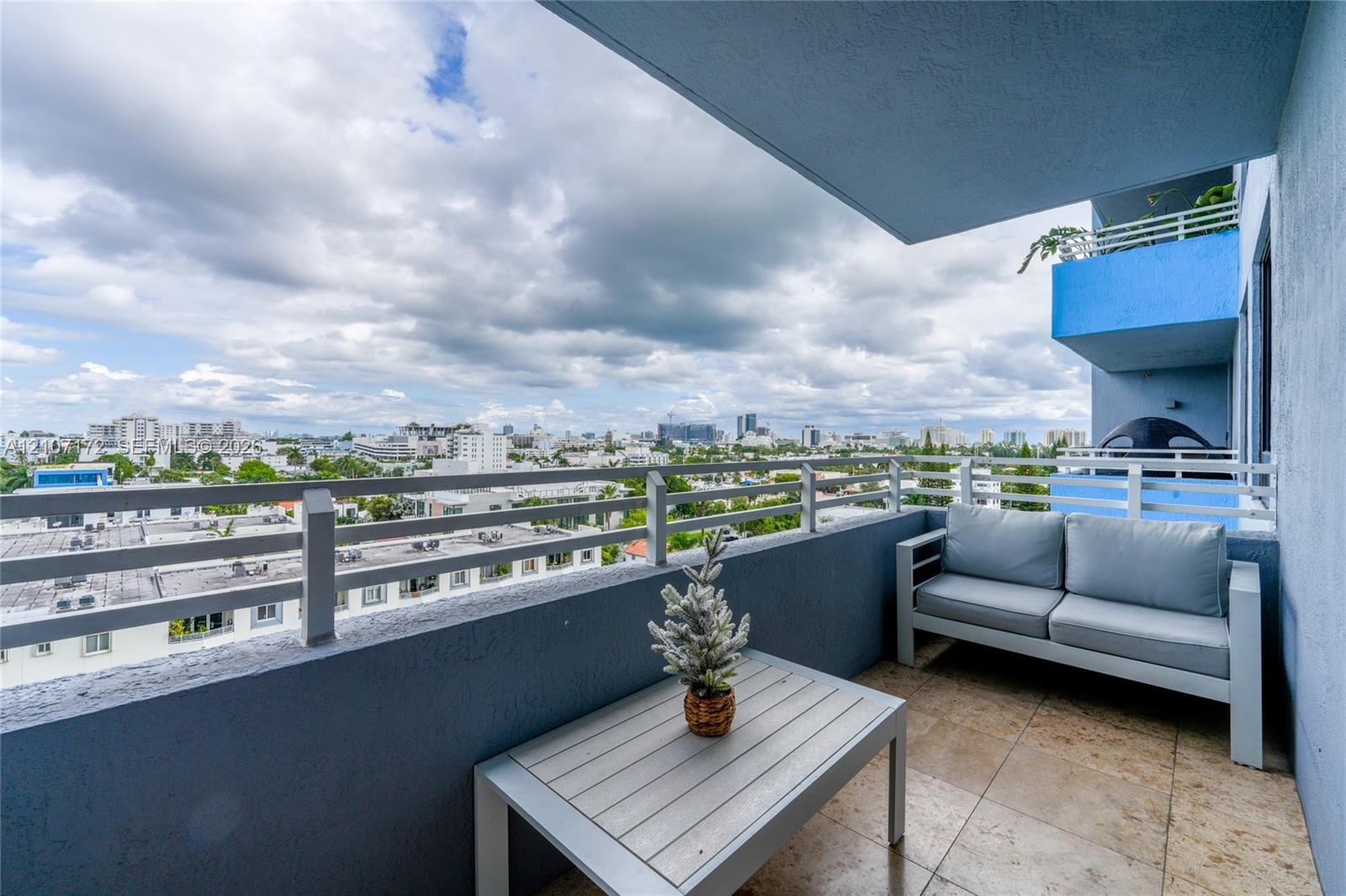 Covered balcony featuring tile flooring and horizontal metal railing