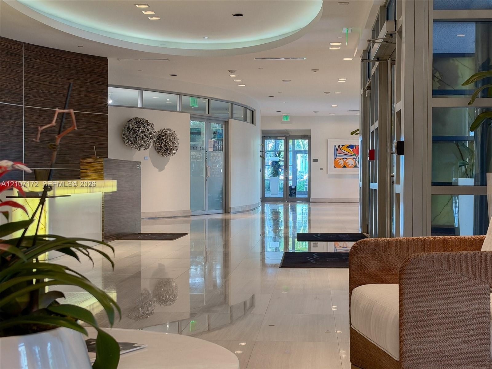 Mail room featuring integrated banks of metal parcel lockers, a central island with a solid surface countertop, wood-toned paneled walls with grid det