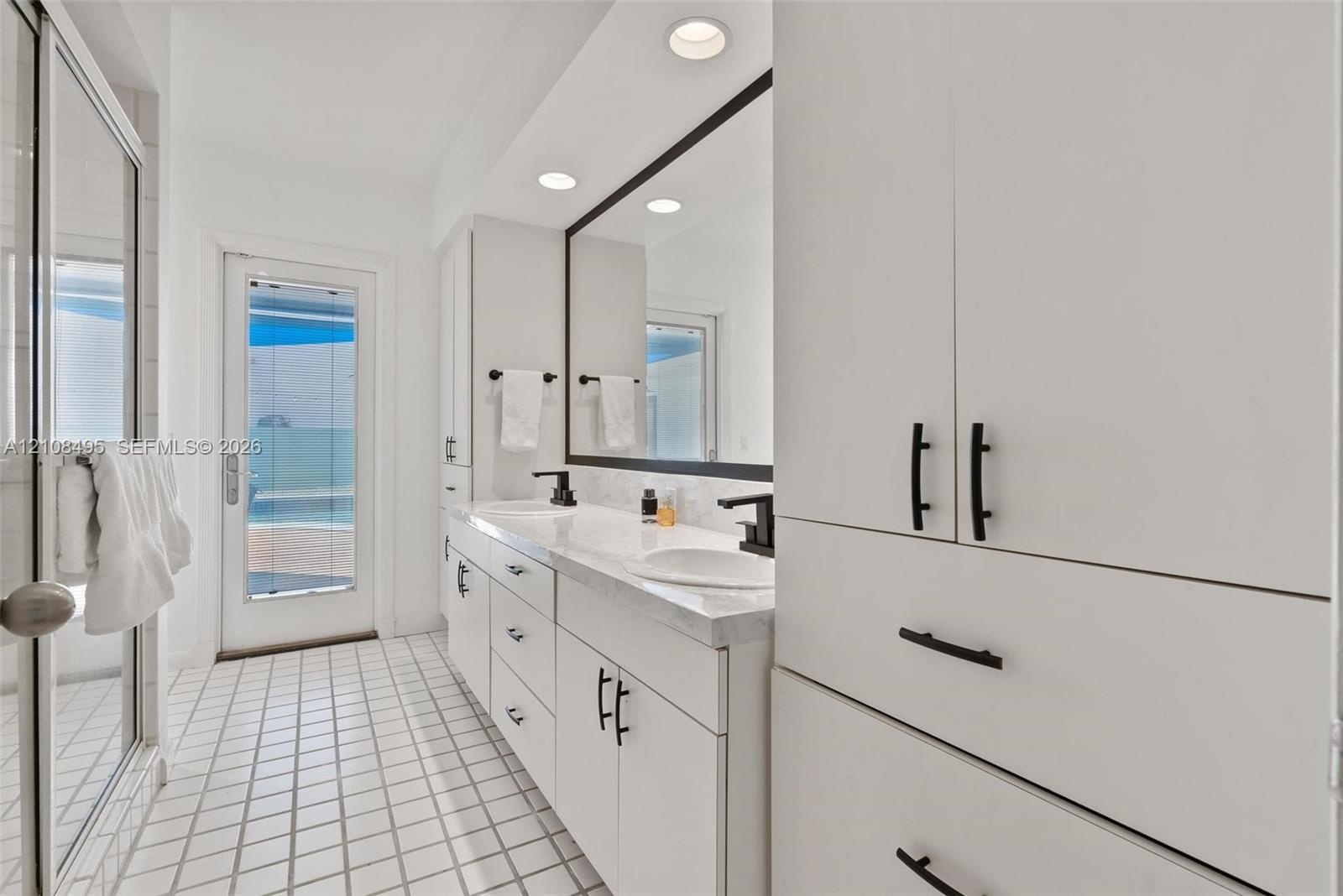 Neutral-toned tile flooring, recessed lighting, and a low-profile flush-mount ceiling fixture