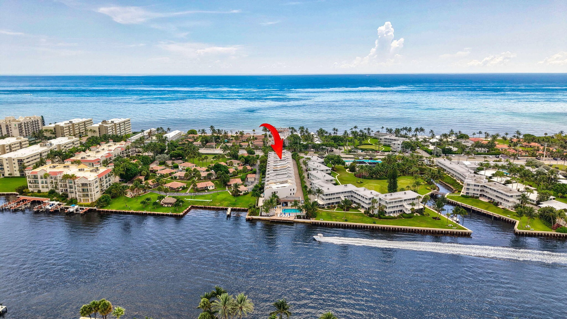 Waterfront property featuring direct ocean access, a bright blue ocean backdrop, and surrounded by canals