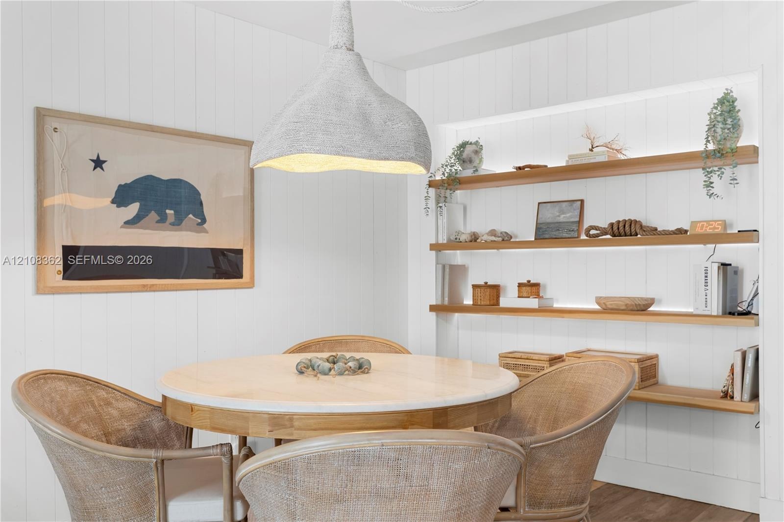Built-in wall niche with recessed shelving, integrated linear lighting, and vertical plank wall paneling, complemented by a textured organic-form pend