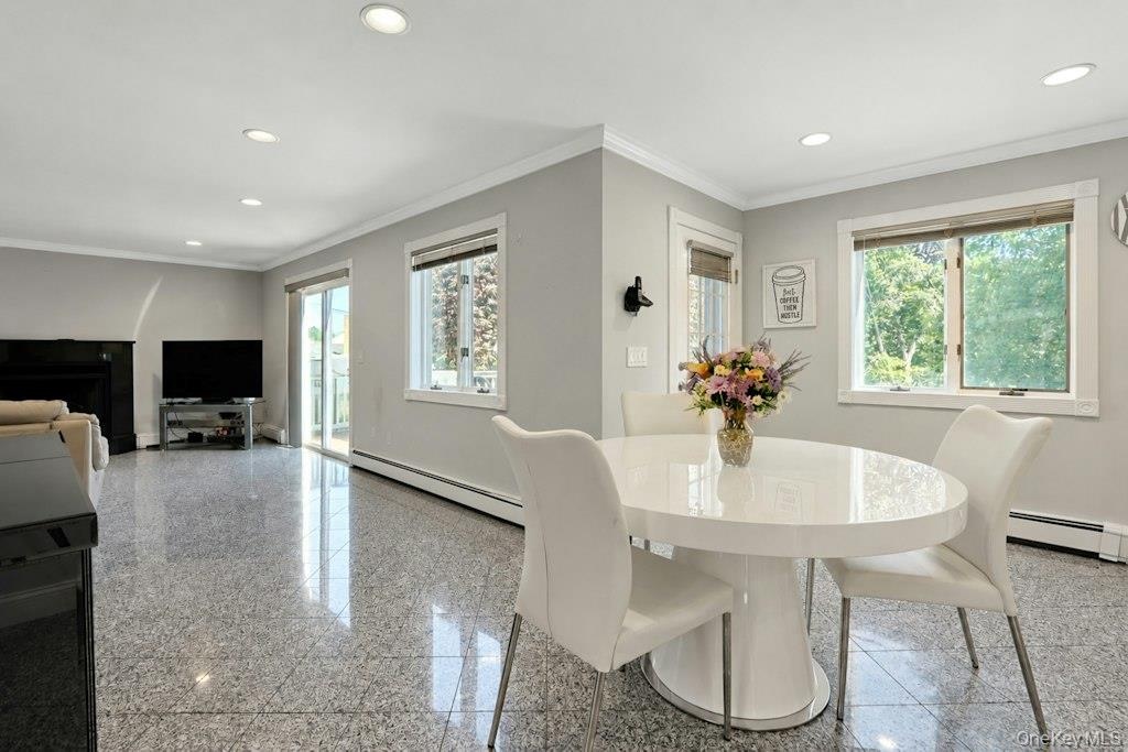 Eat-in kitchen opens to family room with door to deck plus sliders