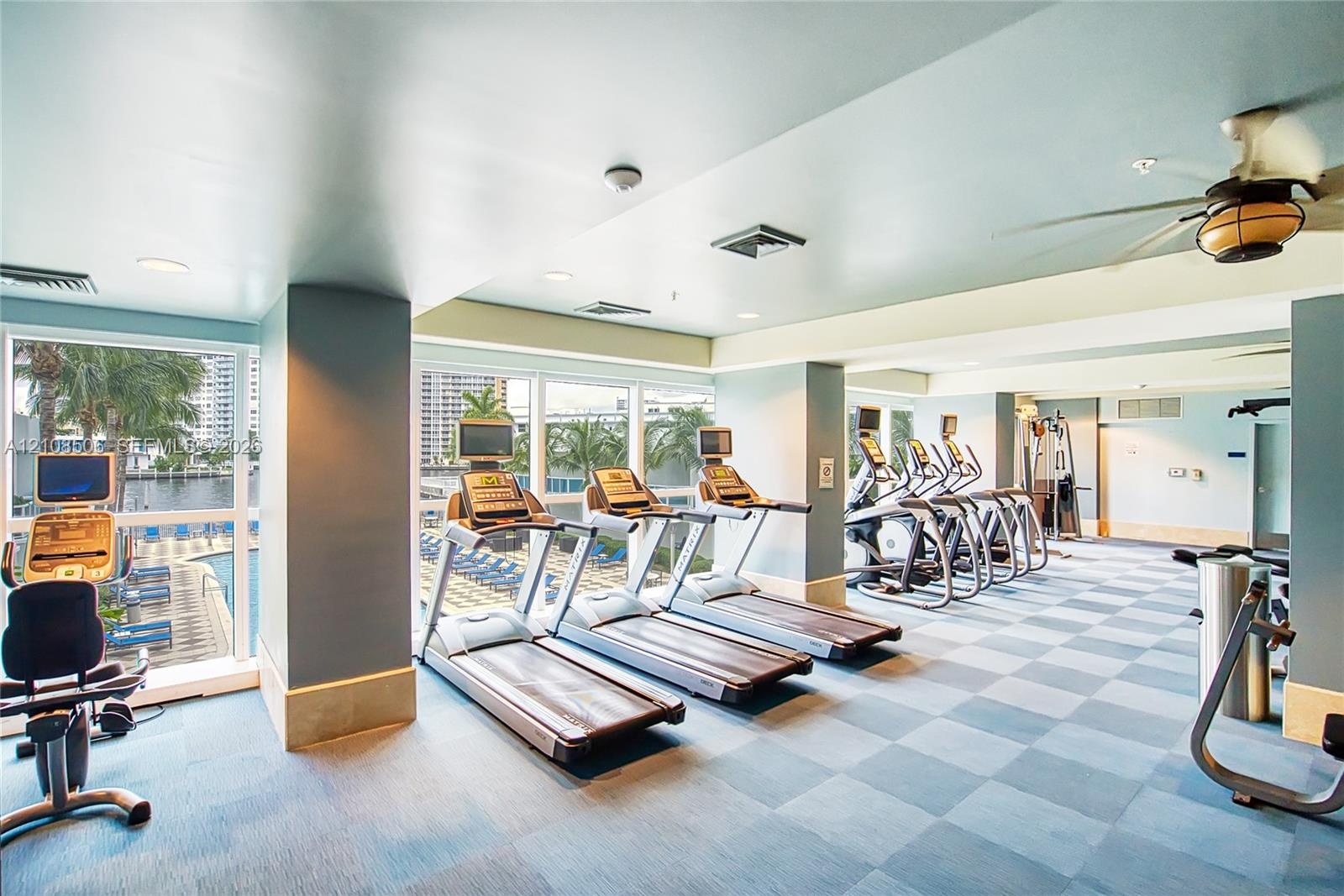 Fitness center featuring checkered flooring, recessed lighting, ceiling fan, and floor-to-ceiling windows