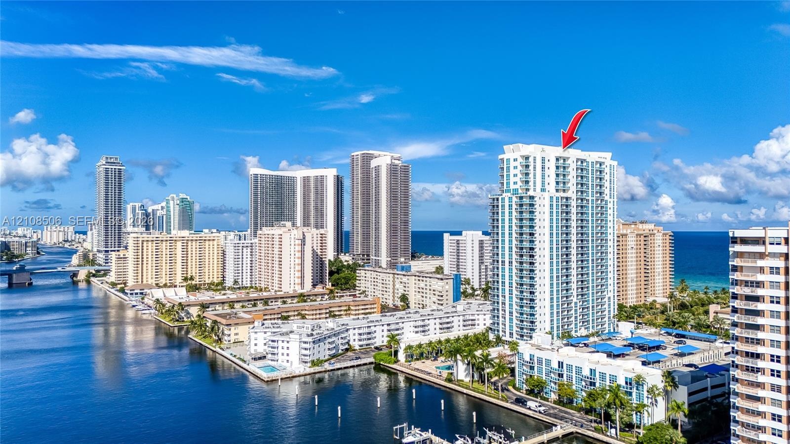 High-rise building featuring private balconies, floor-to-ceiling windows, and a waterfront location