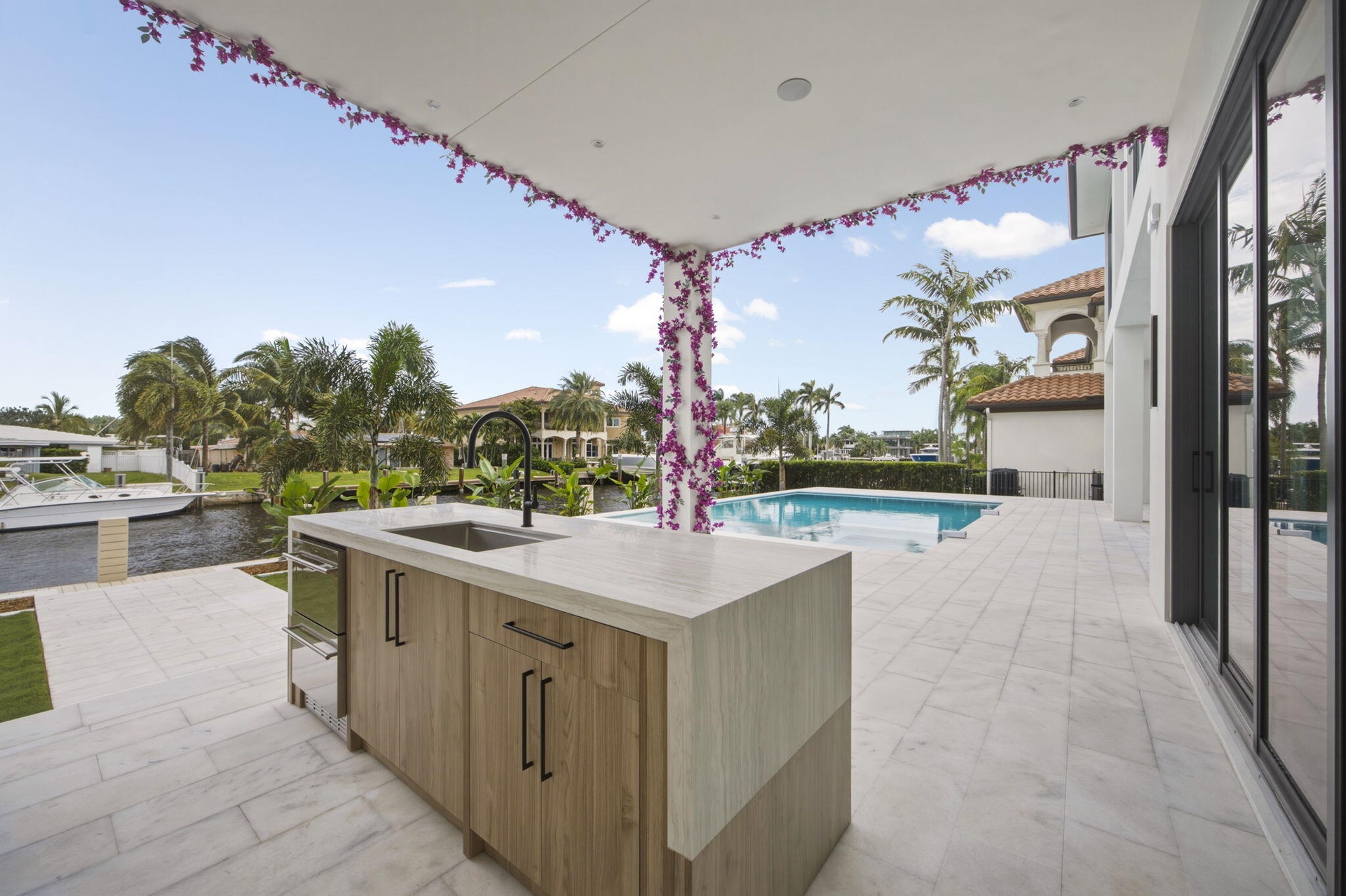 Outdoor cabinetry with Neolith Countertops and waterfall gas grill, fridge