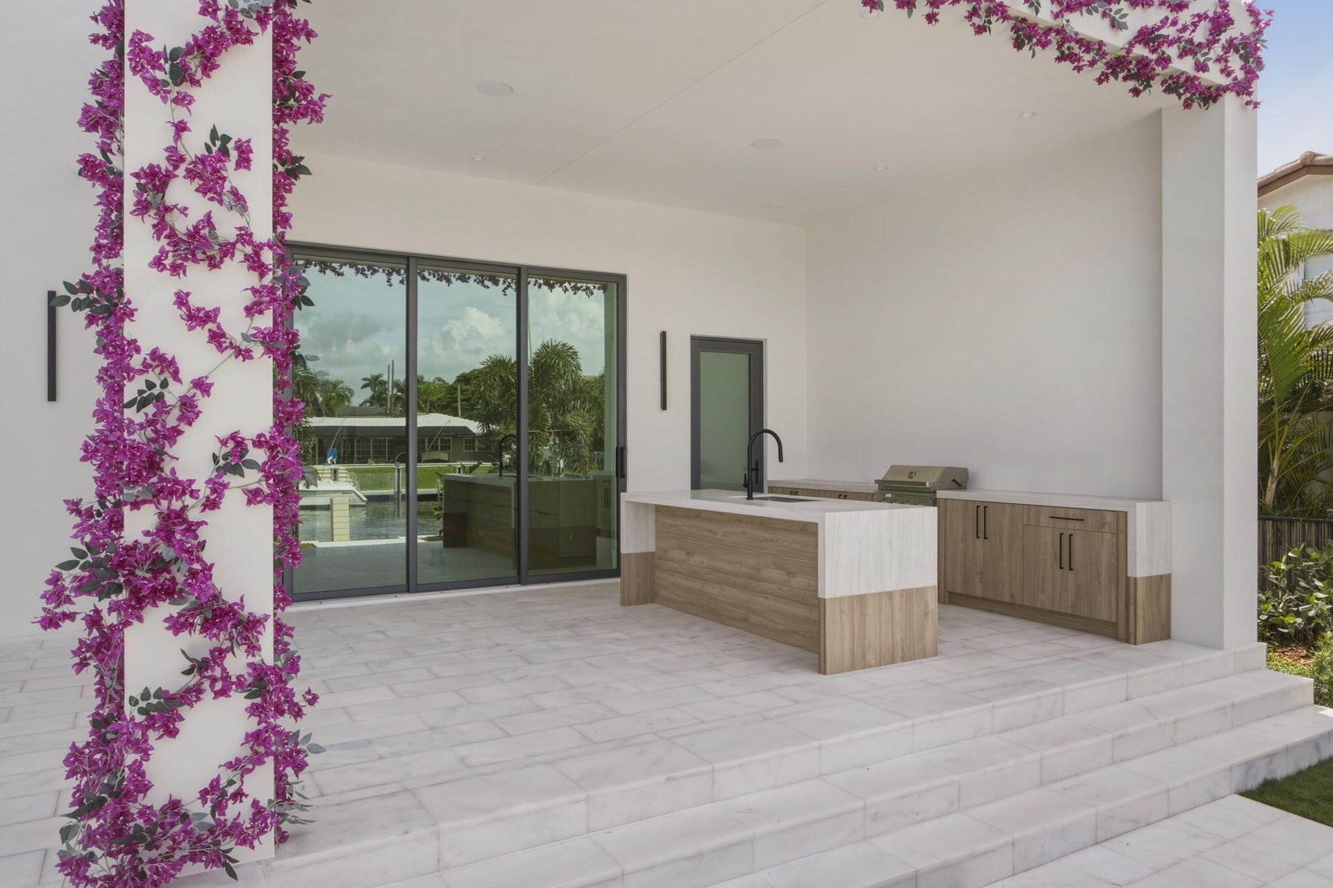 Outdoor cabinetry with Neolith Countertops and waterfall gas grill, fridge