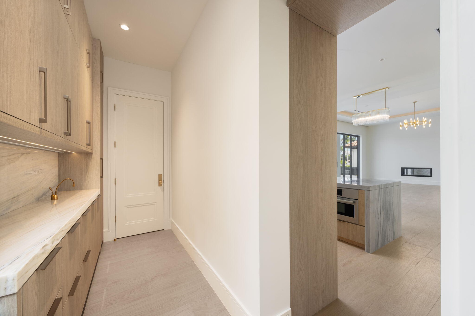 pantry floor to ceiling cabinetry , marble counter & backsplash and instahot faucet. ac closet at end of room