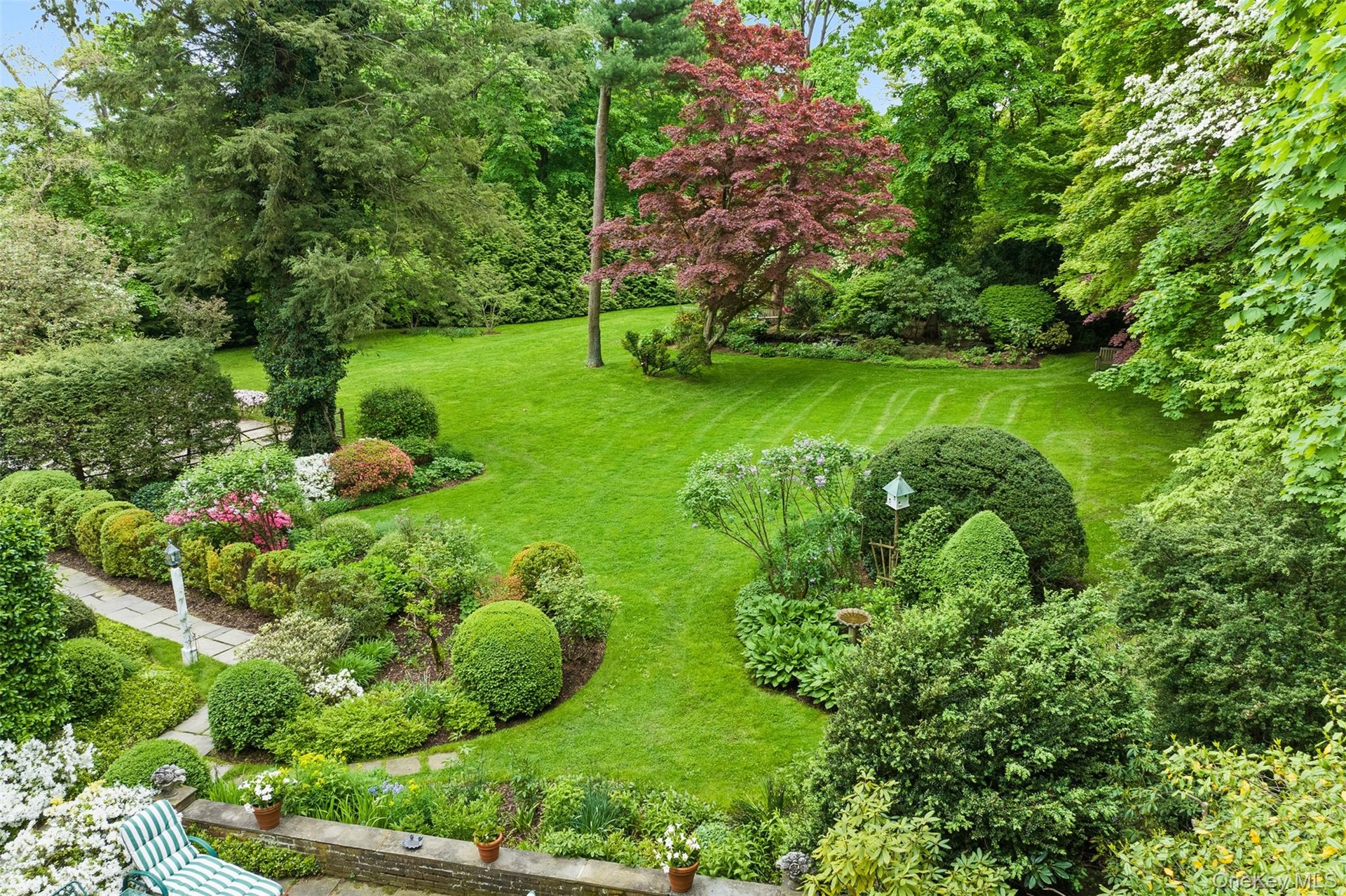 English gardens frame the walkways and bluestone terrace