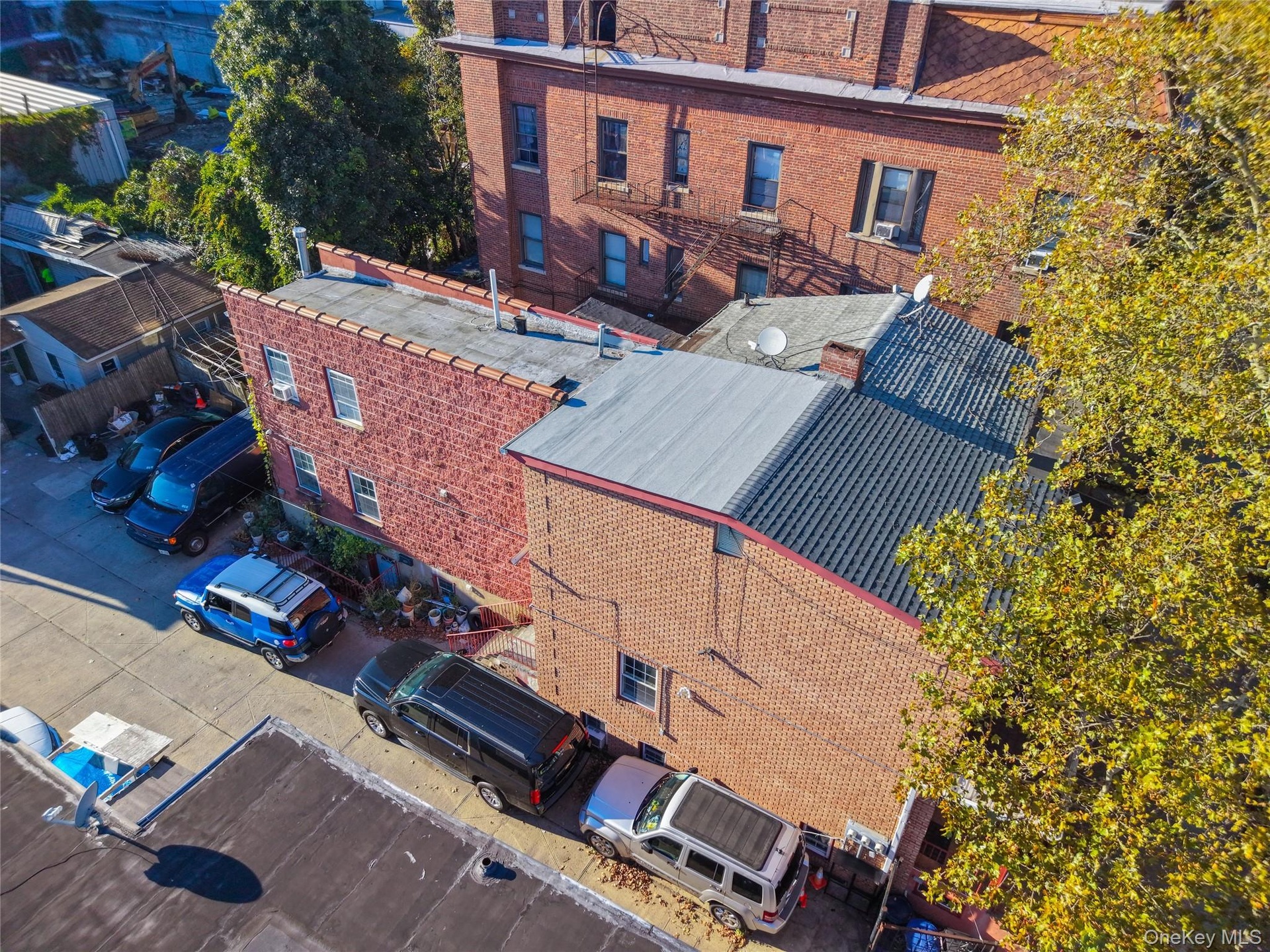 Multi-story brick exterior featuring a flat roofline and integrated off-street parking