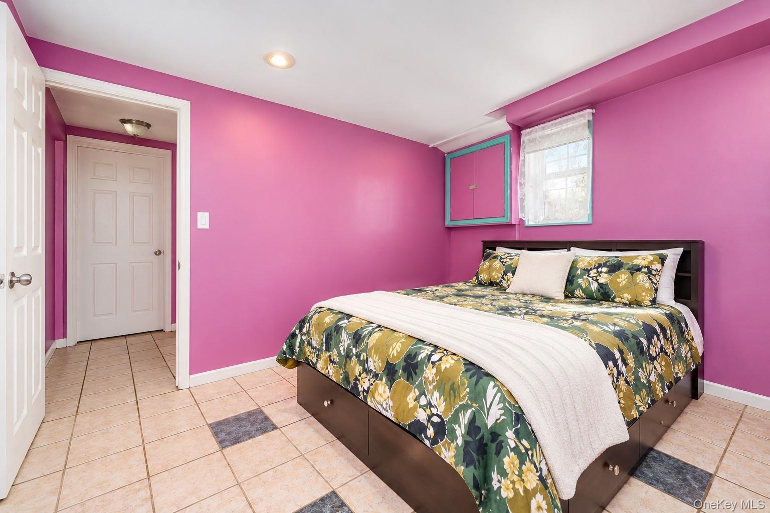 Room featuring tile flooring with decorative inlay, recessed ceiling lighting, a window with exterior exposure, and a built-in wall cabinet with paint
