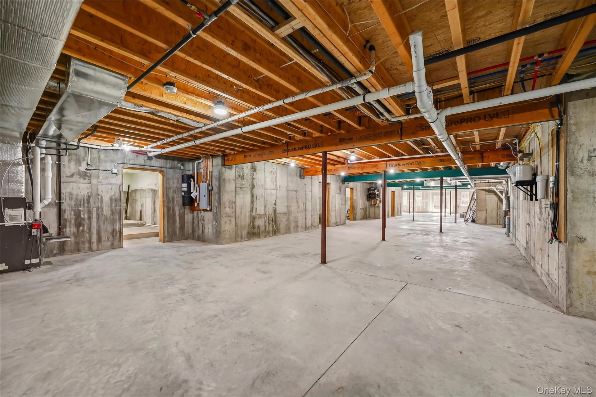 Unfinished lower level featuring exposed wood joist ceilings, poured concrete foundation walls, and concrete flooring. High ceilings!