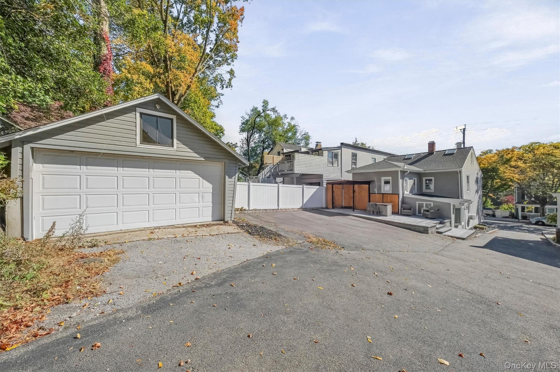 Exceptional property layout featuring a detached 2-car garage, expansive driveway parking for up to 4 additional vehicles, and a custom outdoor kitche